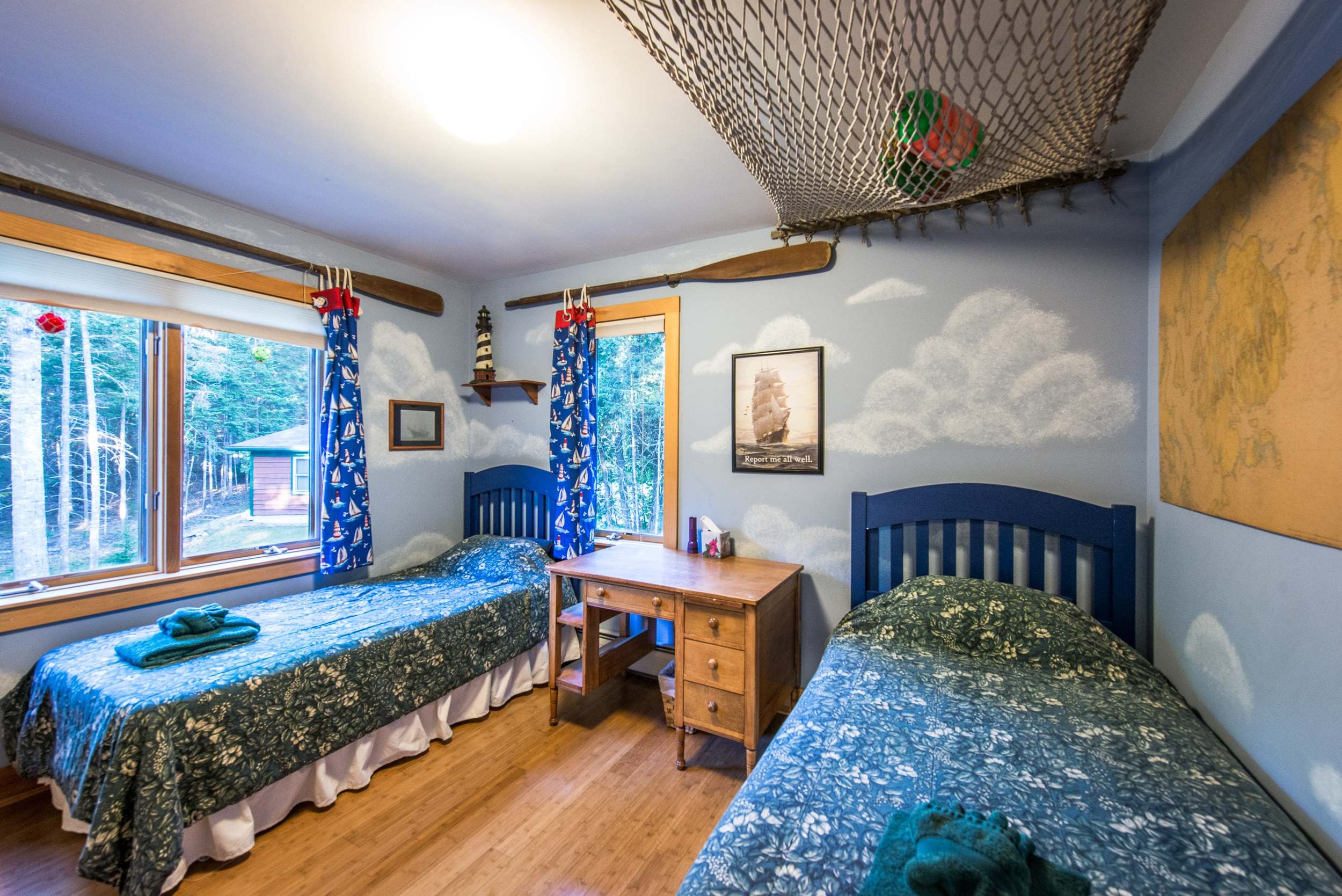  Upstairs bedroom with two twin beds with a historic nautical theme. 