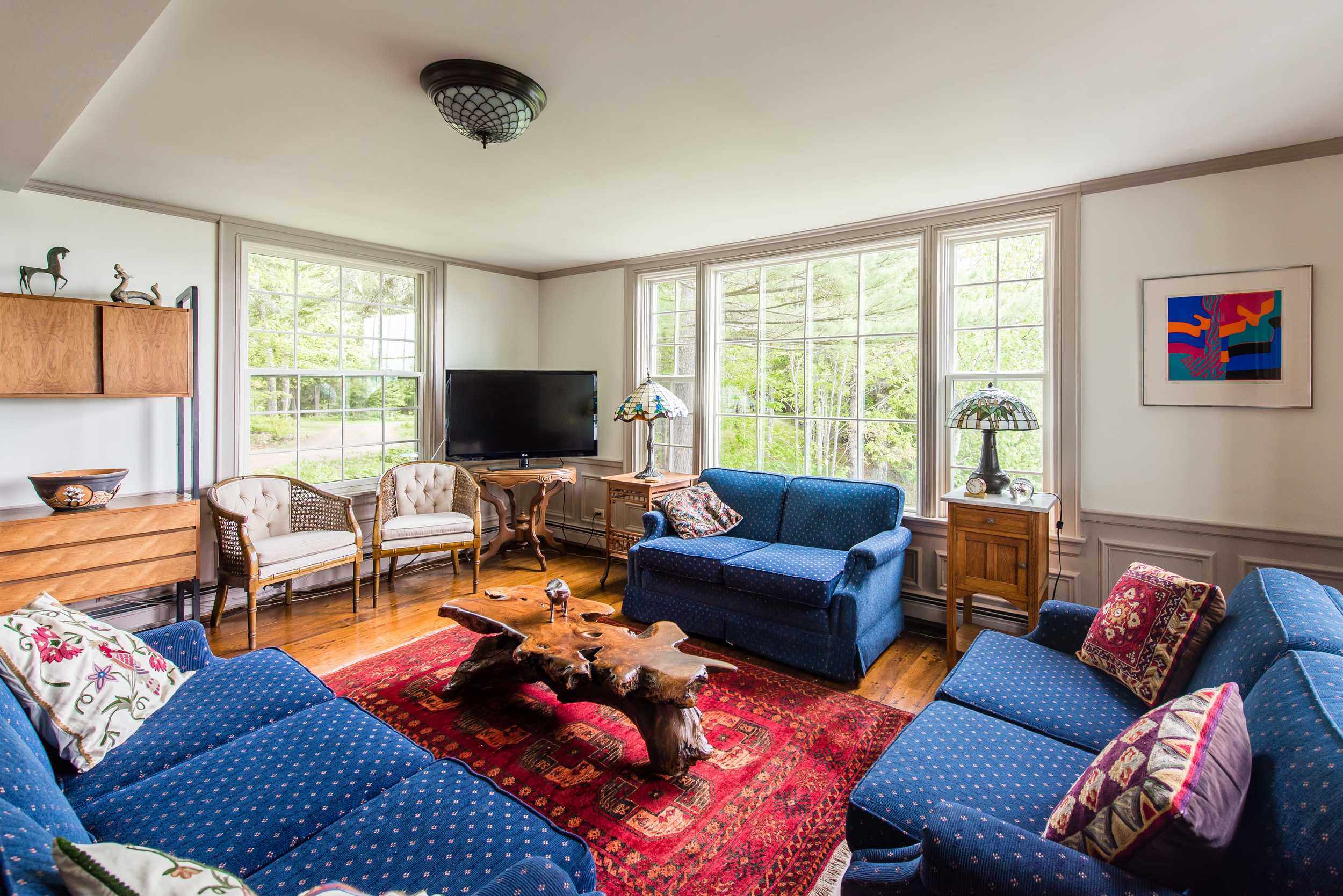 Living room with ocean views, large TV, and ample seating for the whole gang.