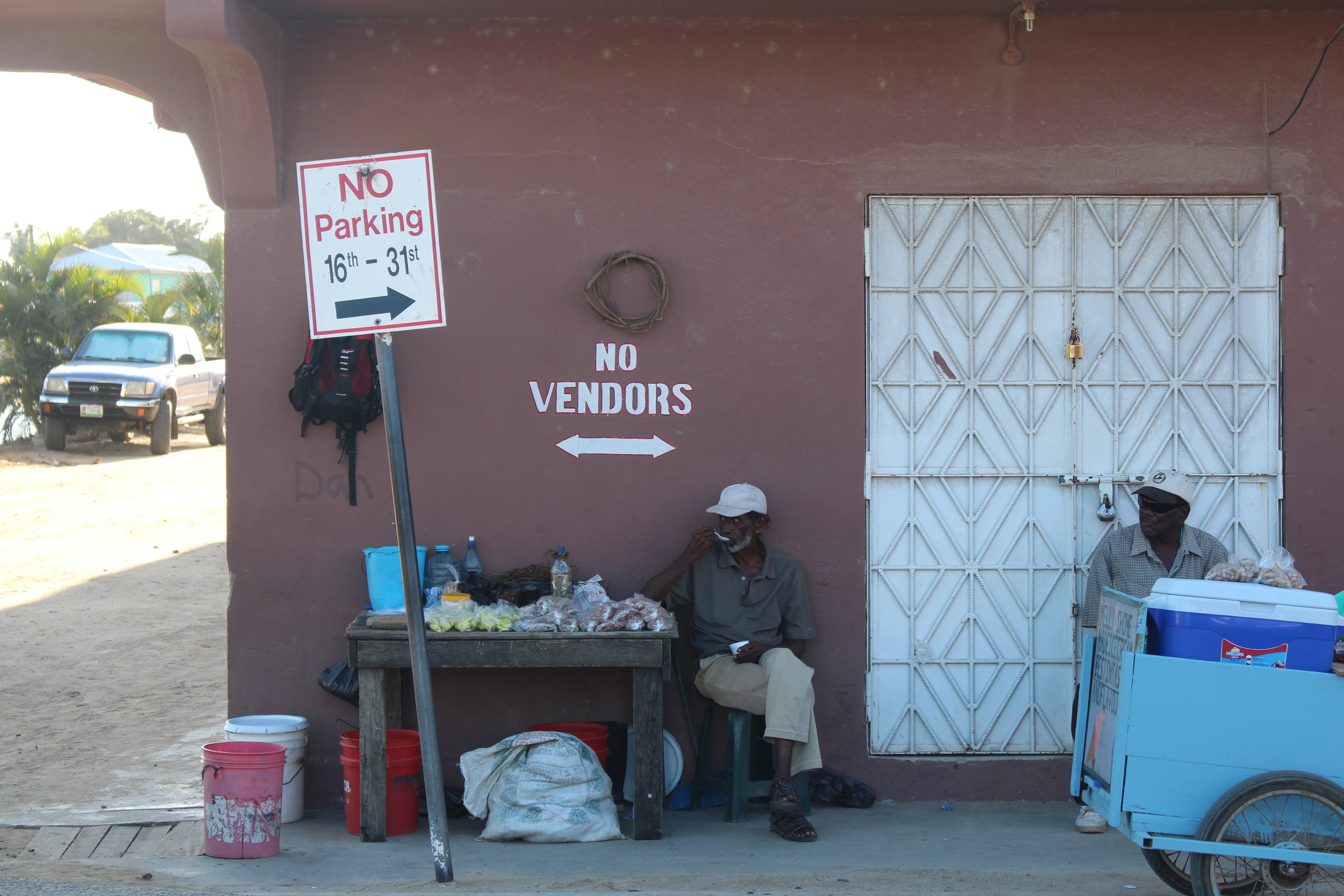A Belizean vendor delightfully ignores the sign