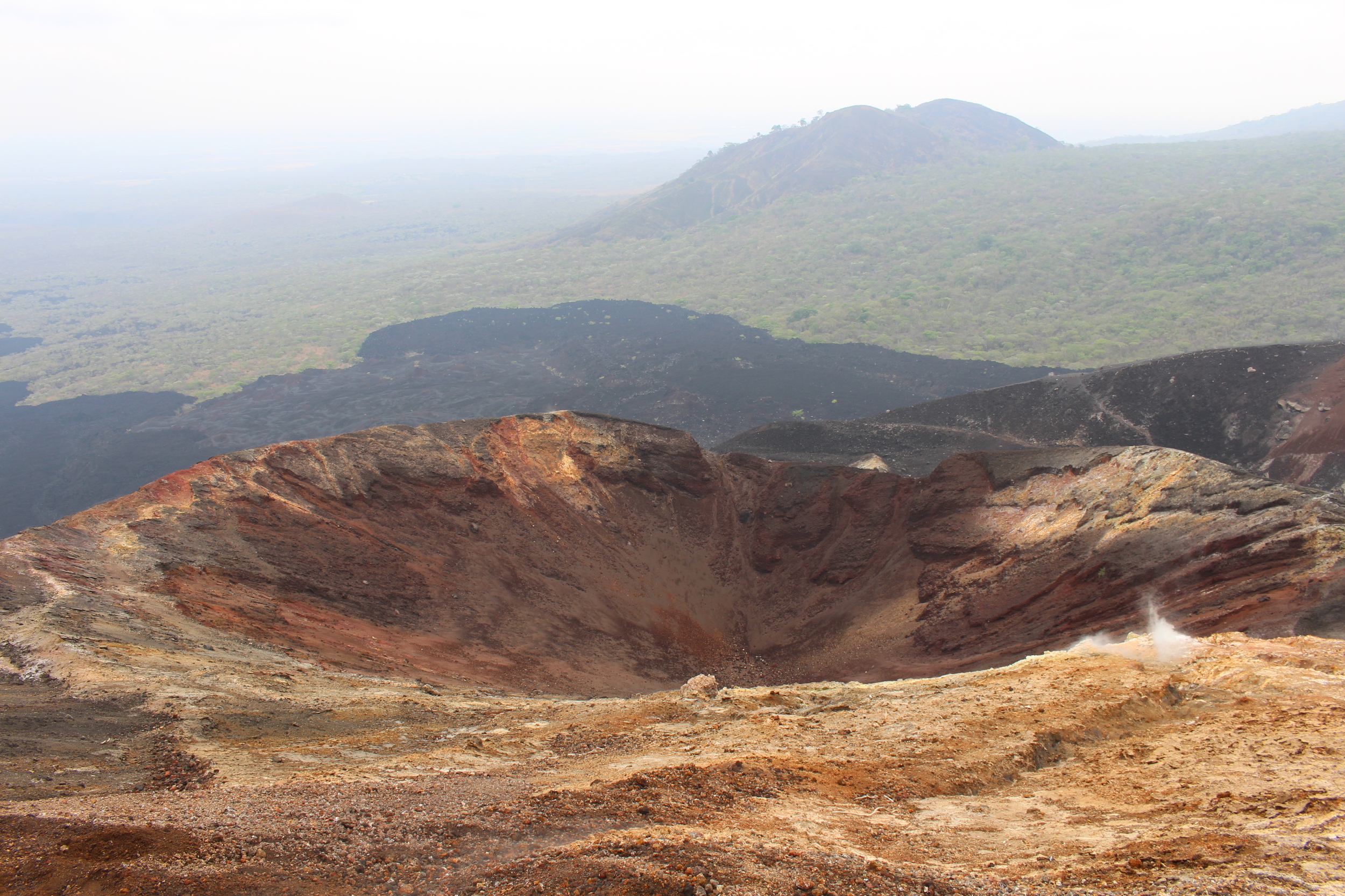 One of Cerro Negro's five craters and the hazy view beyond