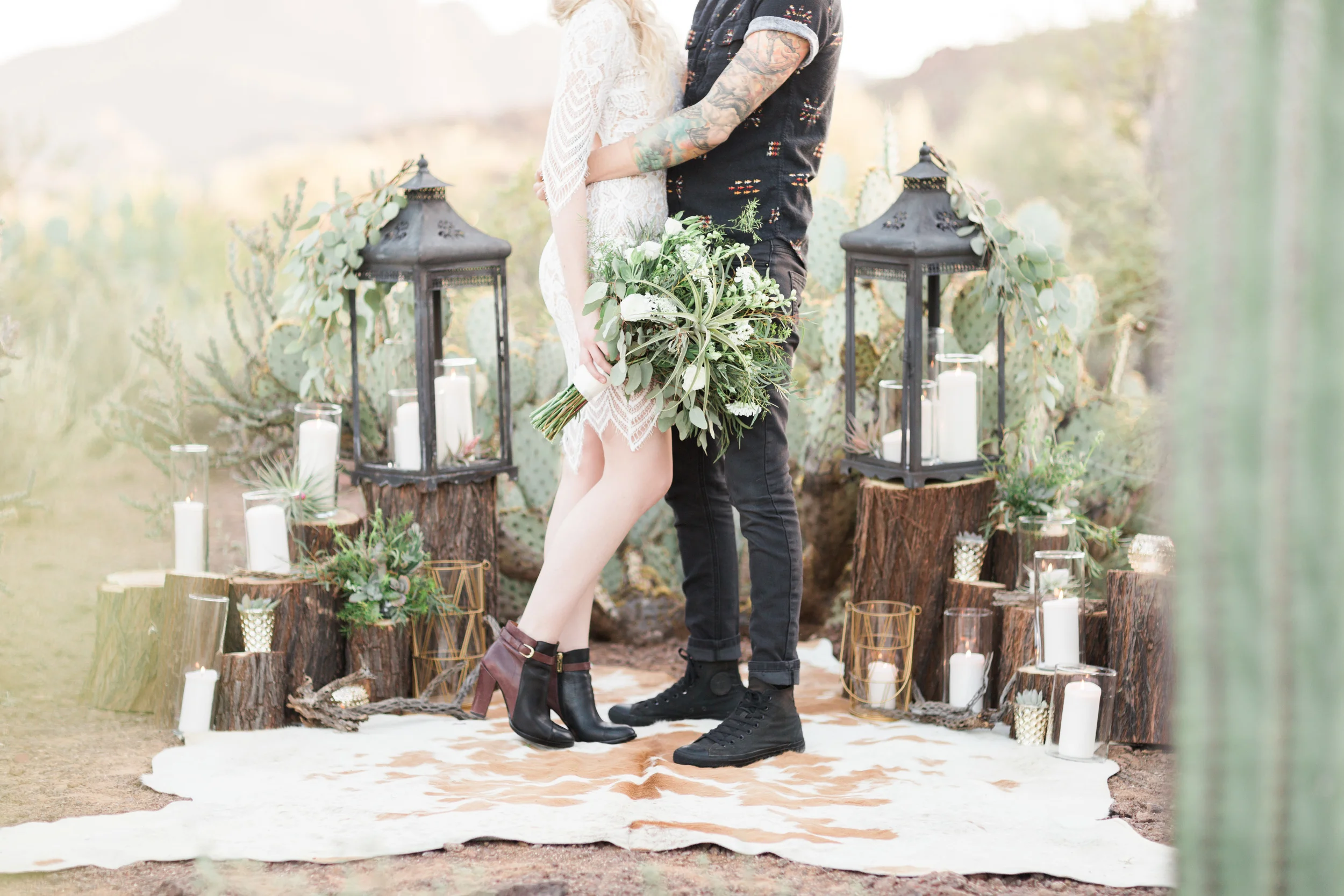 Bride and groom at desert alter with candles