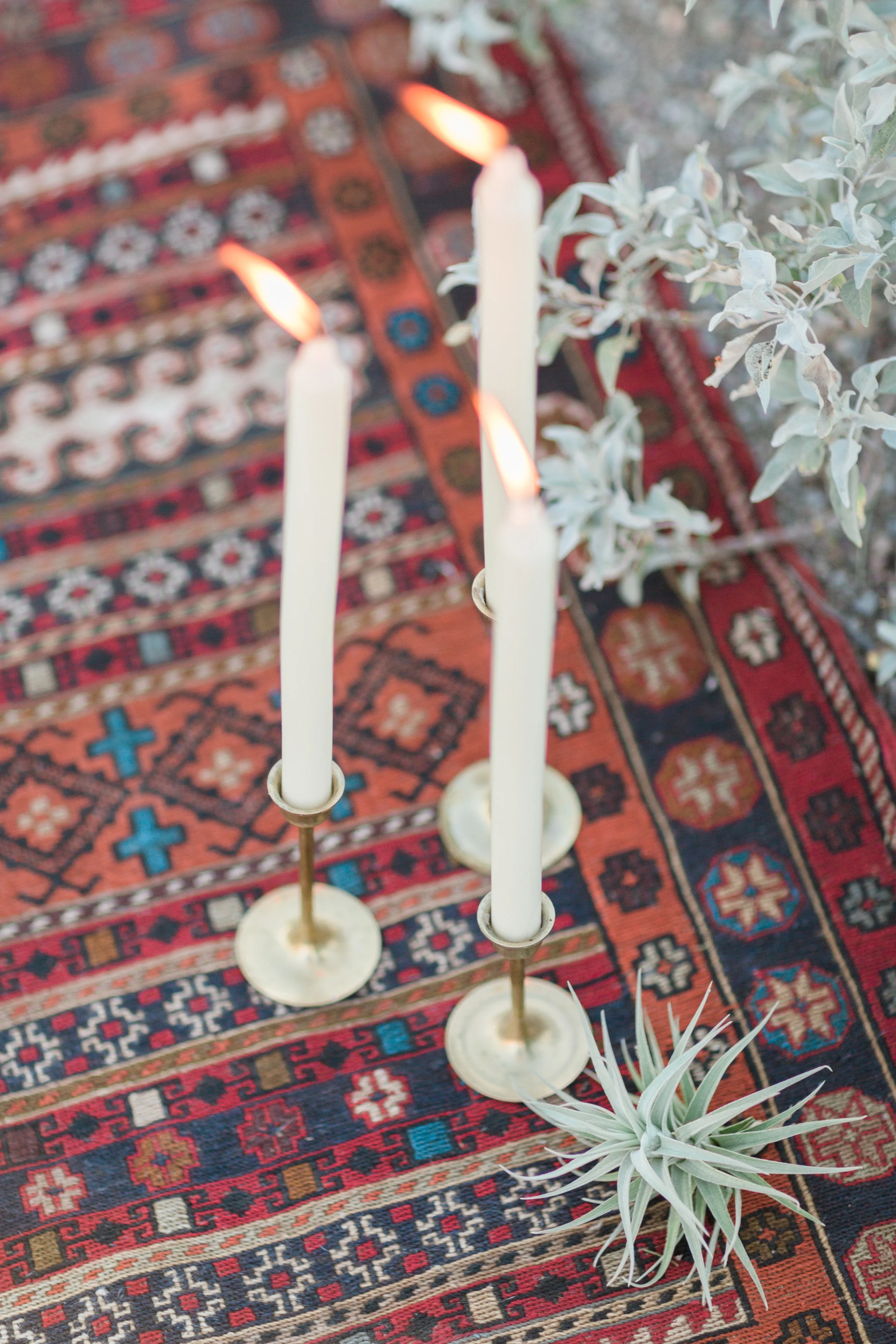 Candles and air plants on a gorgeous Turkish kilim rug