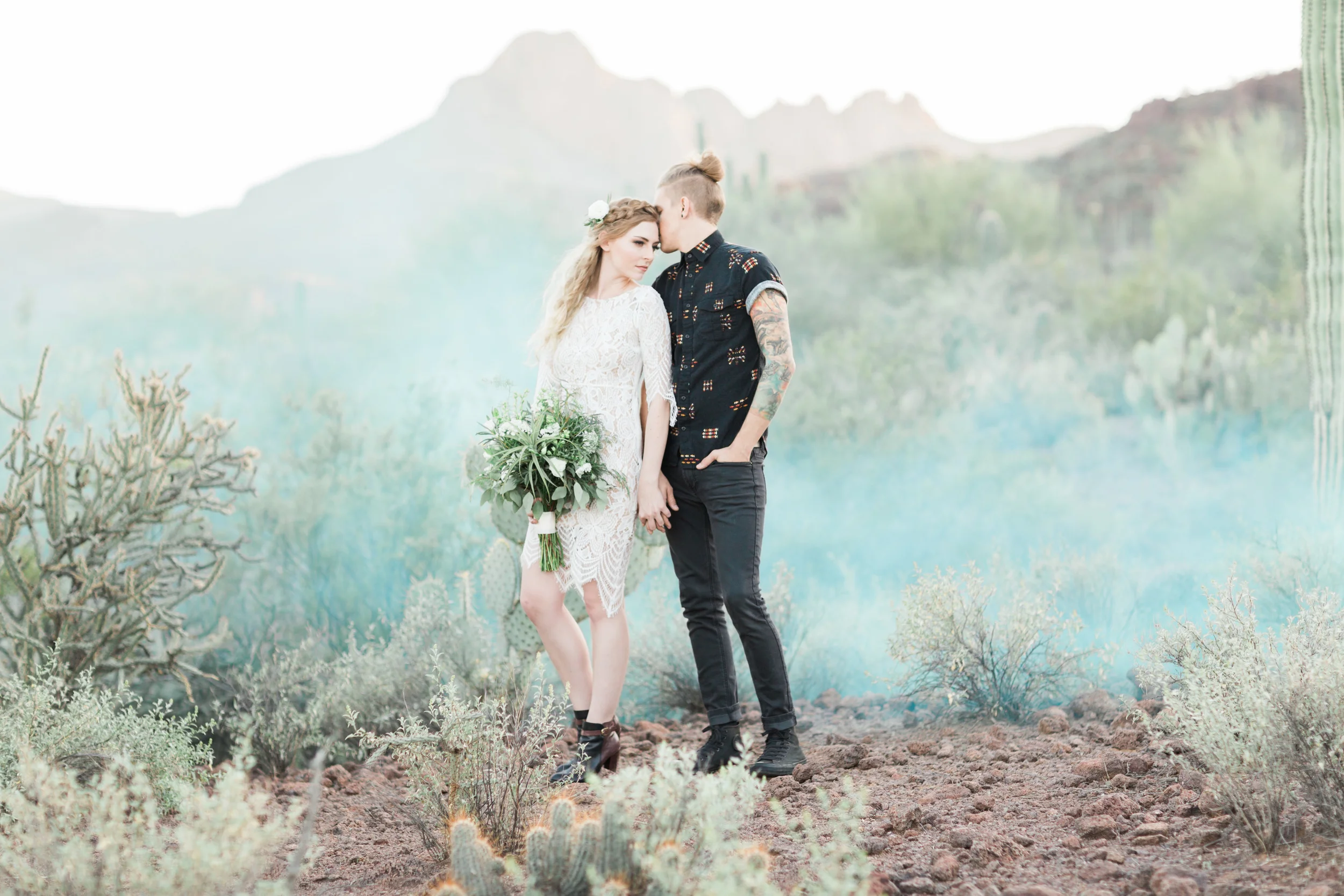Romantic desert anniversary session with cactus and blue smoke bombs