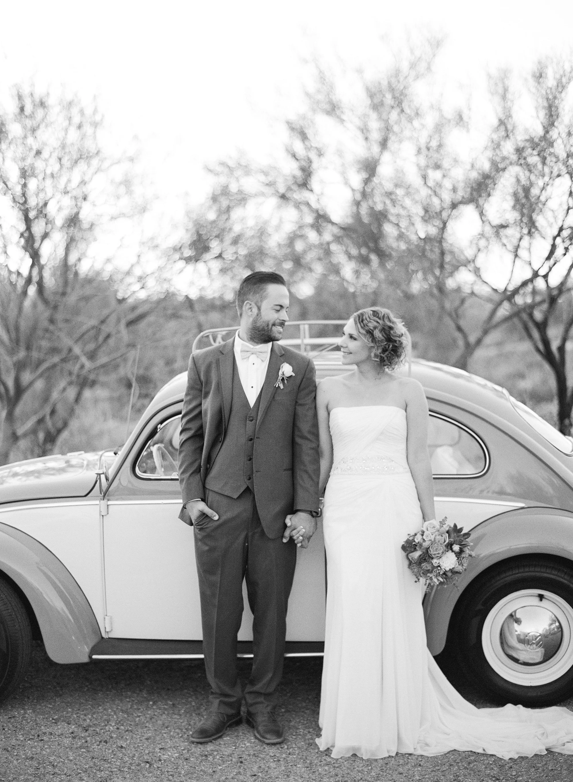Bride and groom smiling looking at each other