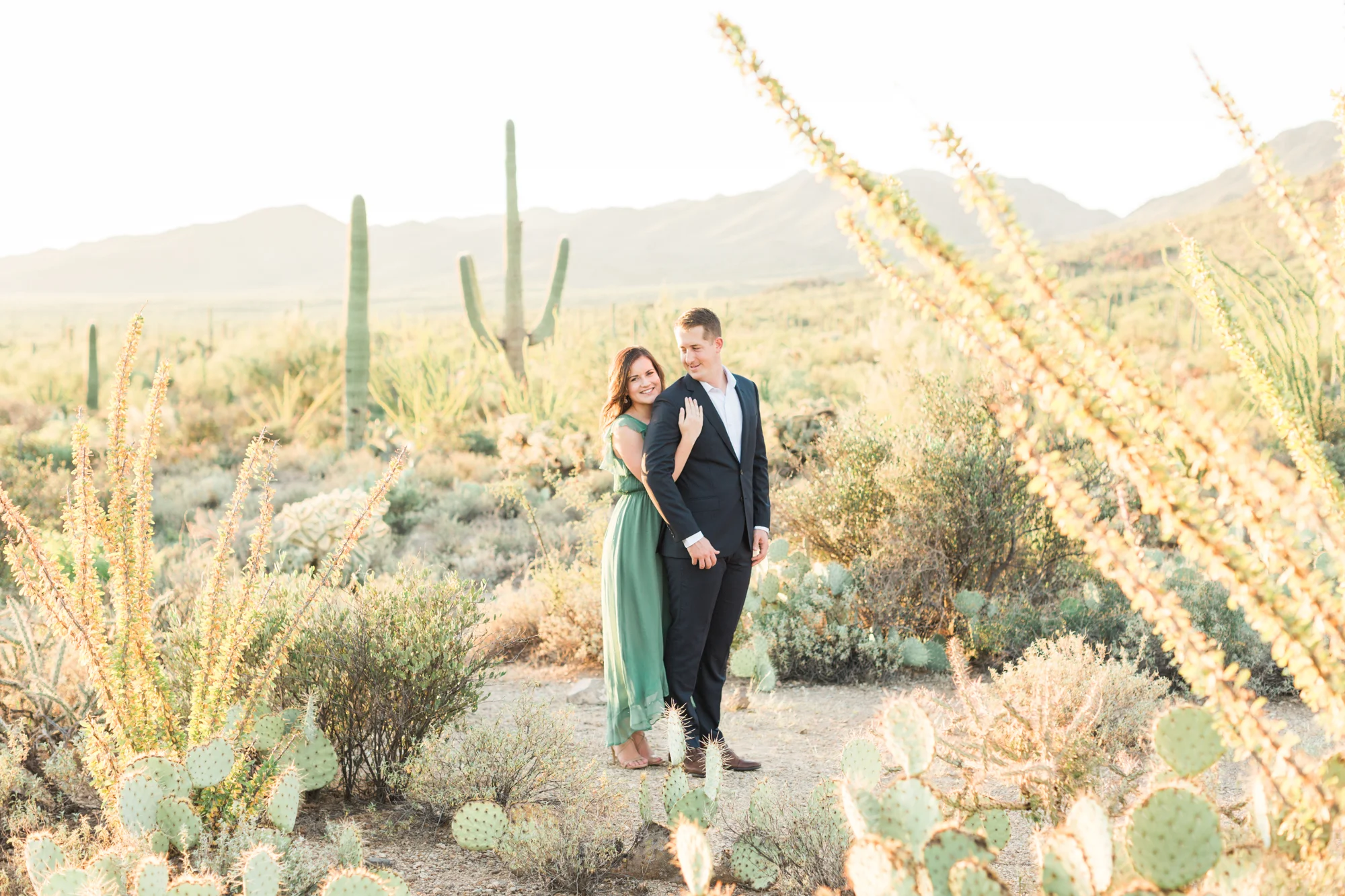 Gorgeous Tucson desert engagement session. Groom adoringly looking at his beautiful bride. 