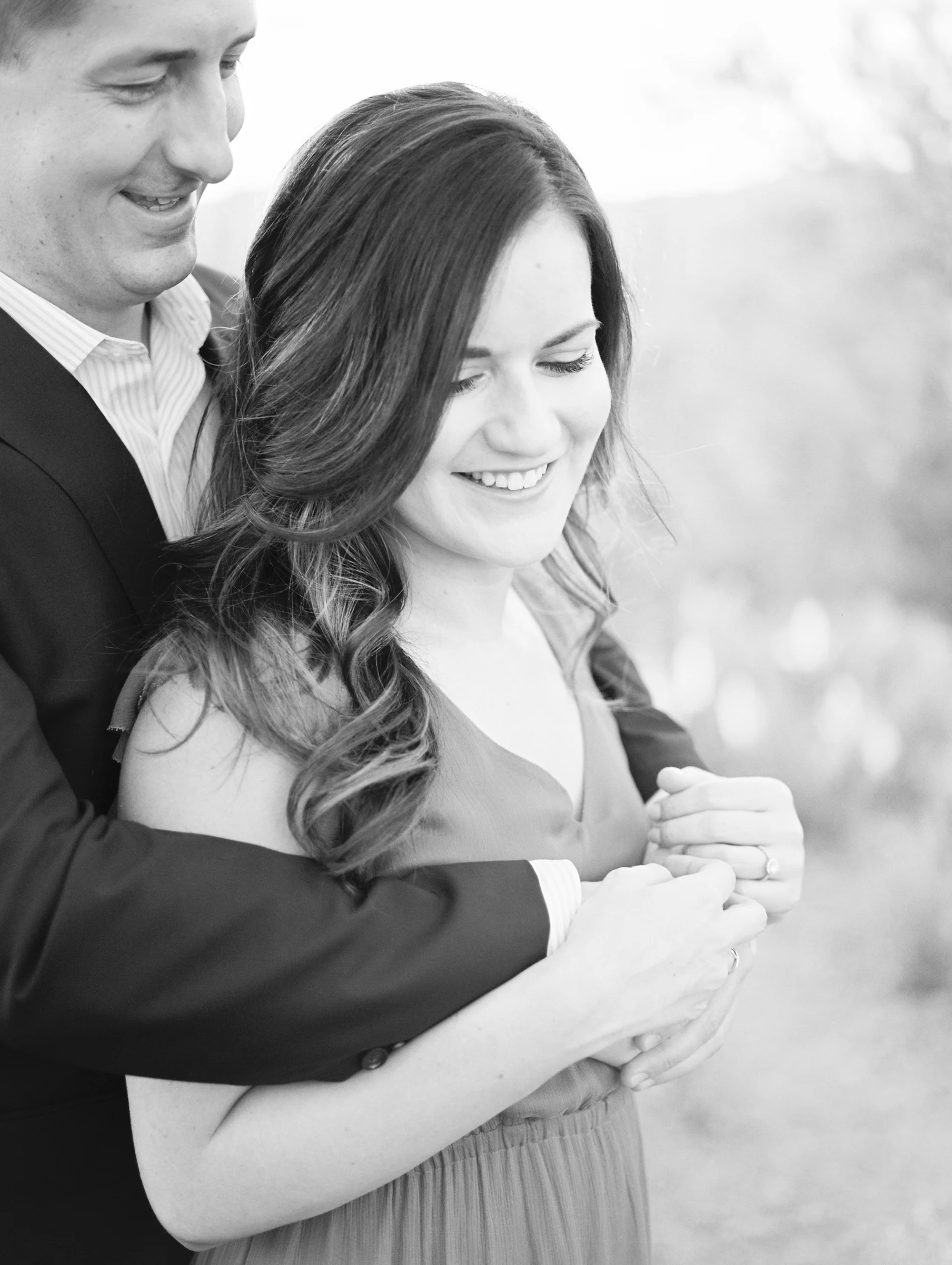 Groom hugging his gorgeous bride to be