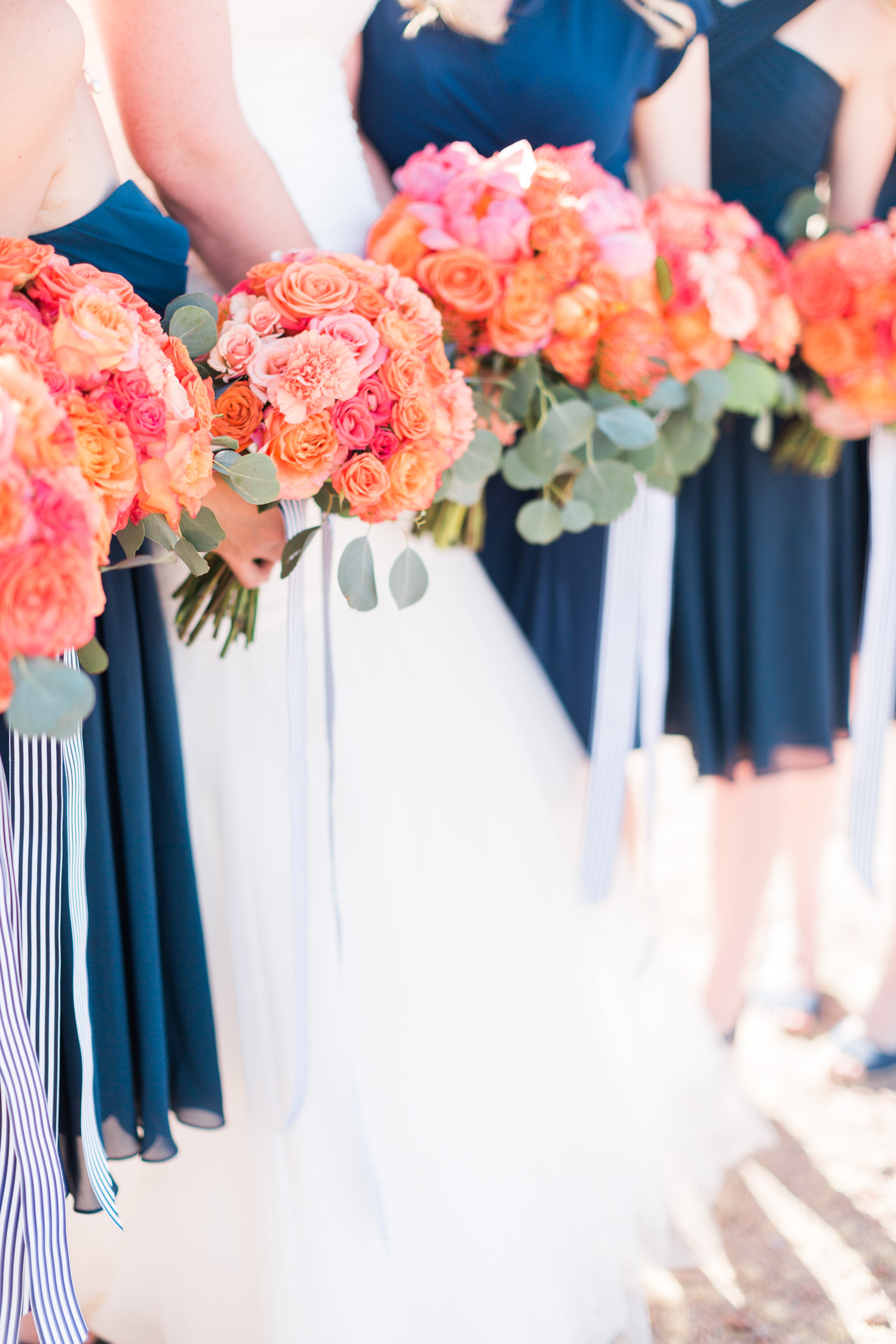 Stunning bouquets with pink peonies, orange and salmon roses with silver dollar eucalyptus. 