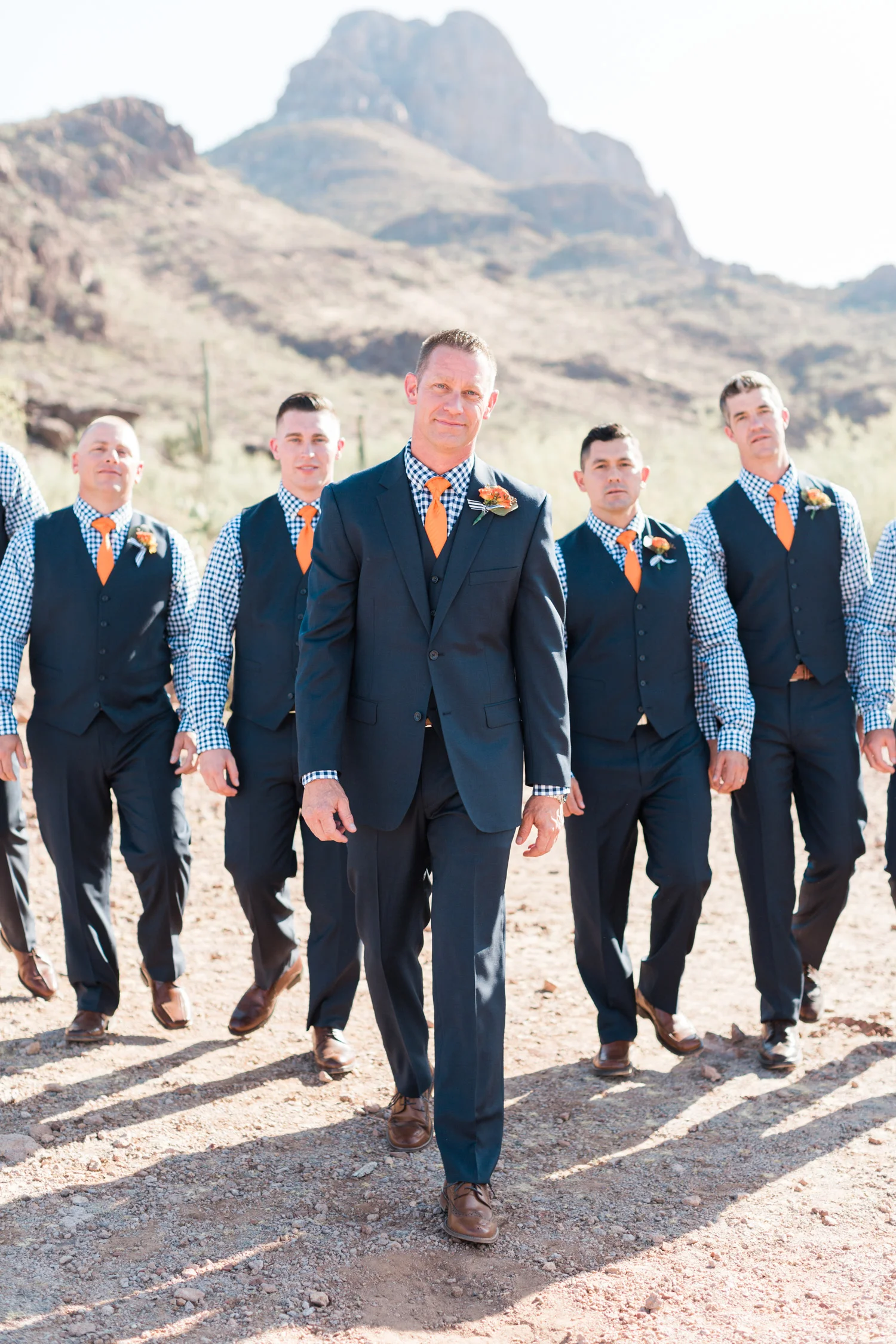 Handsome Groom and groomsmen in navy at Stardance Tucson, walking towards the camera.