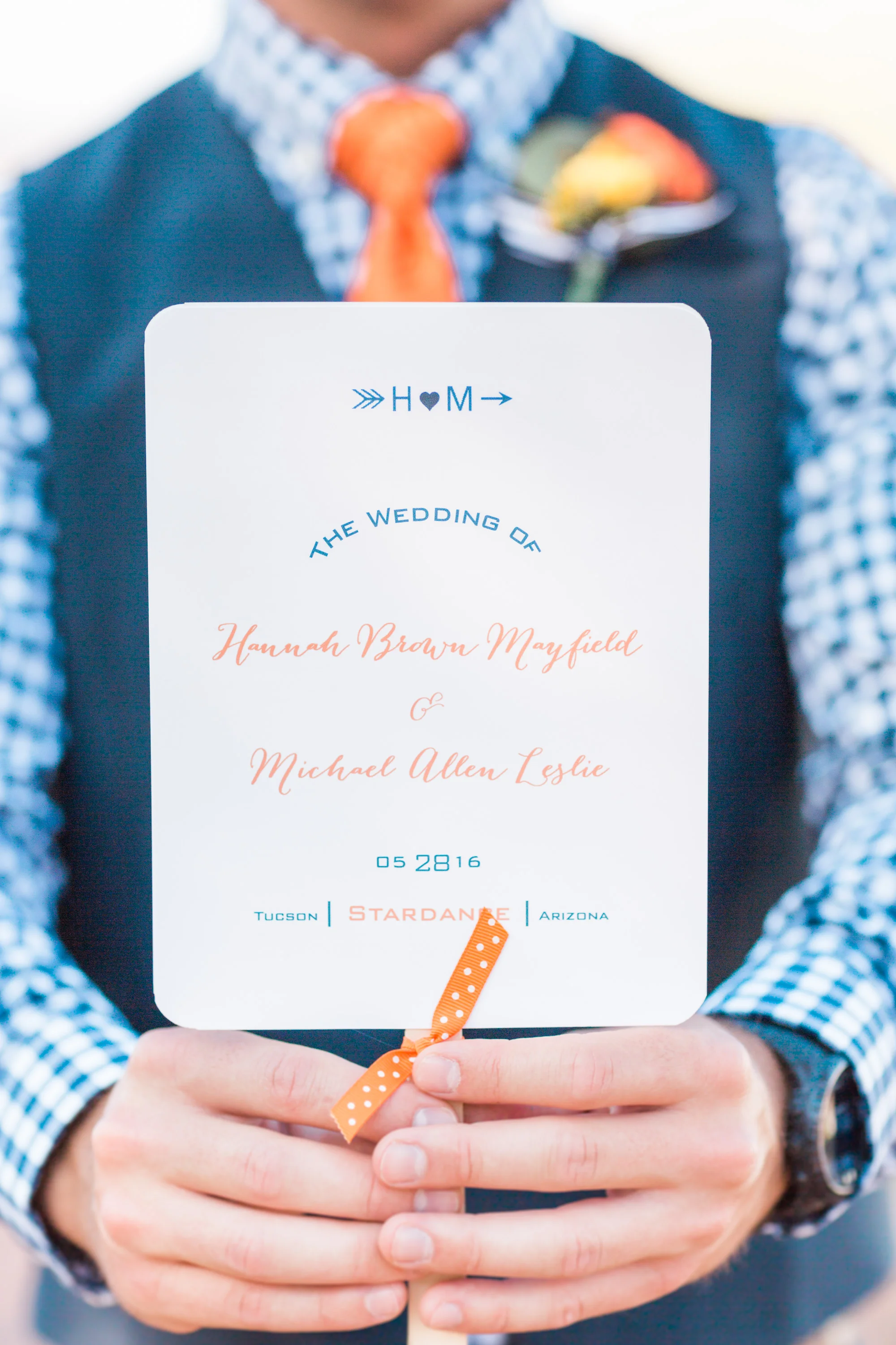 Groomsmen holding the wedding info that guests also used as fans. What a great idea for a hot wedding day! 