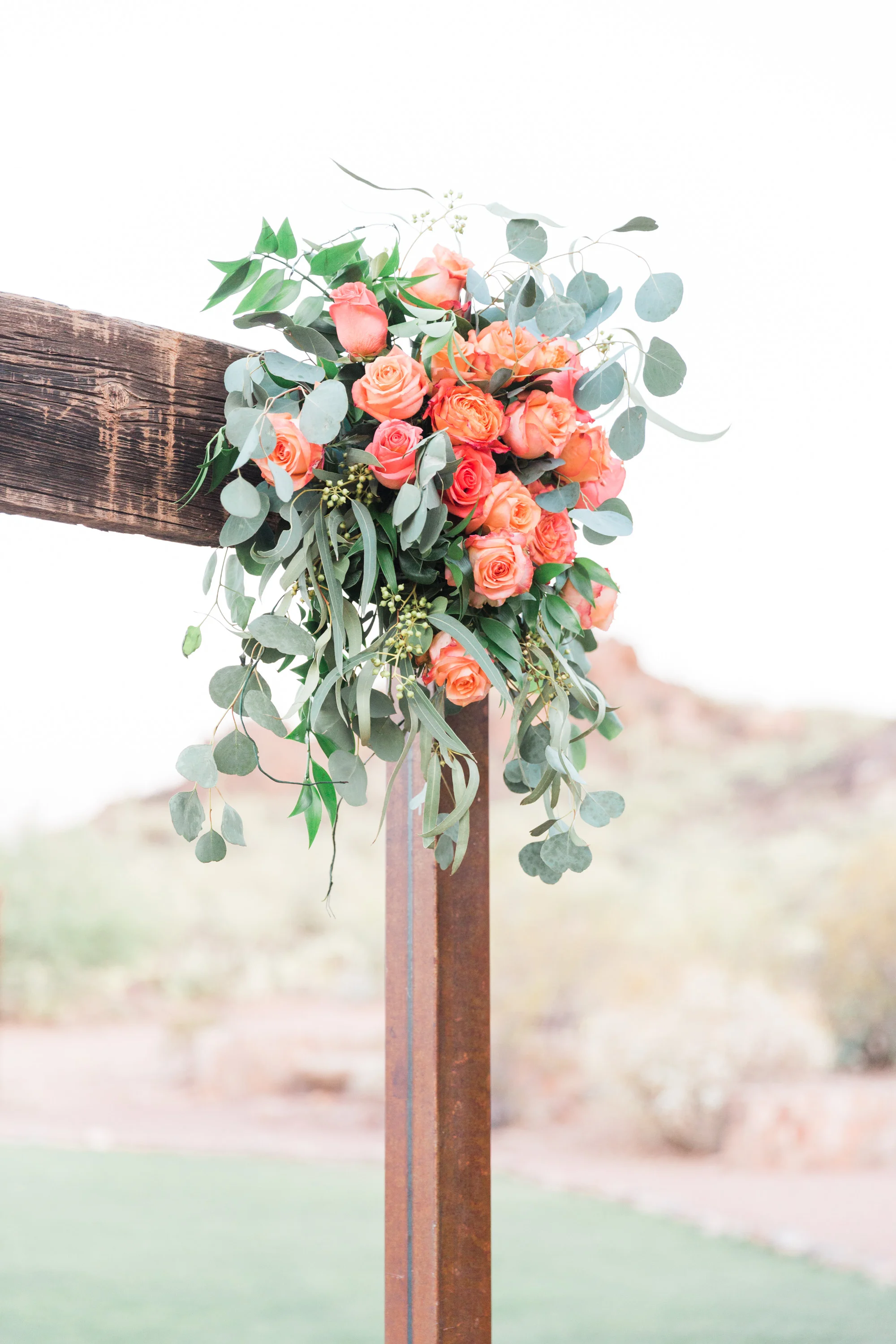 Beautiful arbor draped with florals as you walk into the ceremony site.