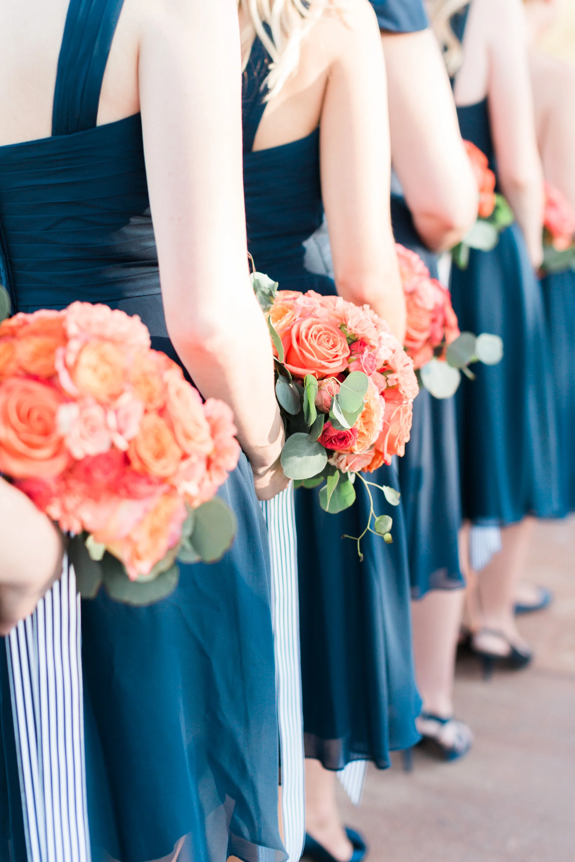 Bridesmaids holding bouquets during the ceremony.
