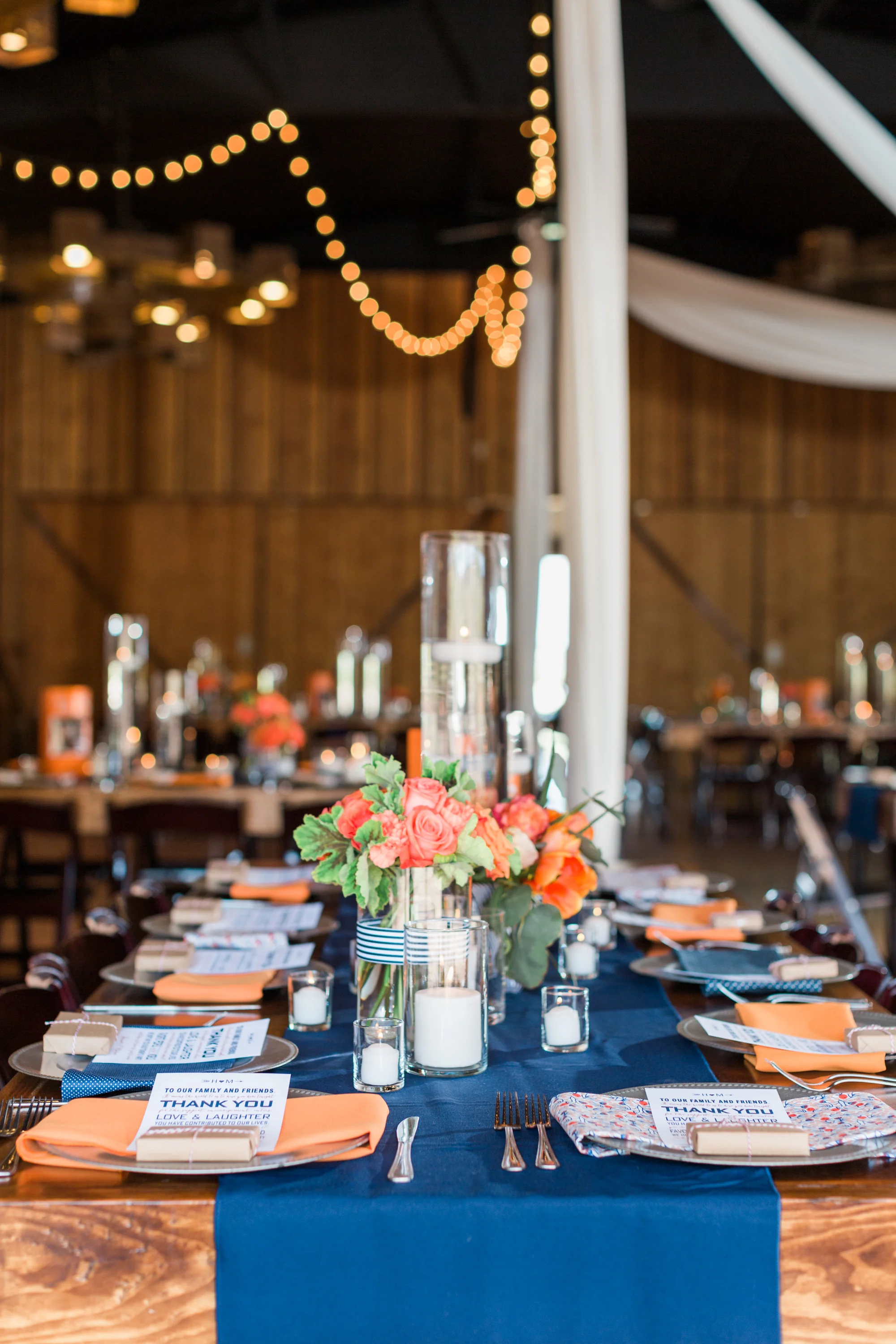 Beautiful navy and orange reception set up at Tucson barn wedding venue, Stardance.