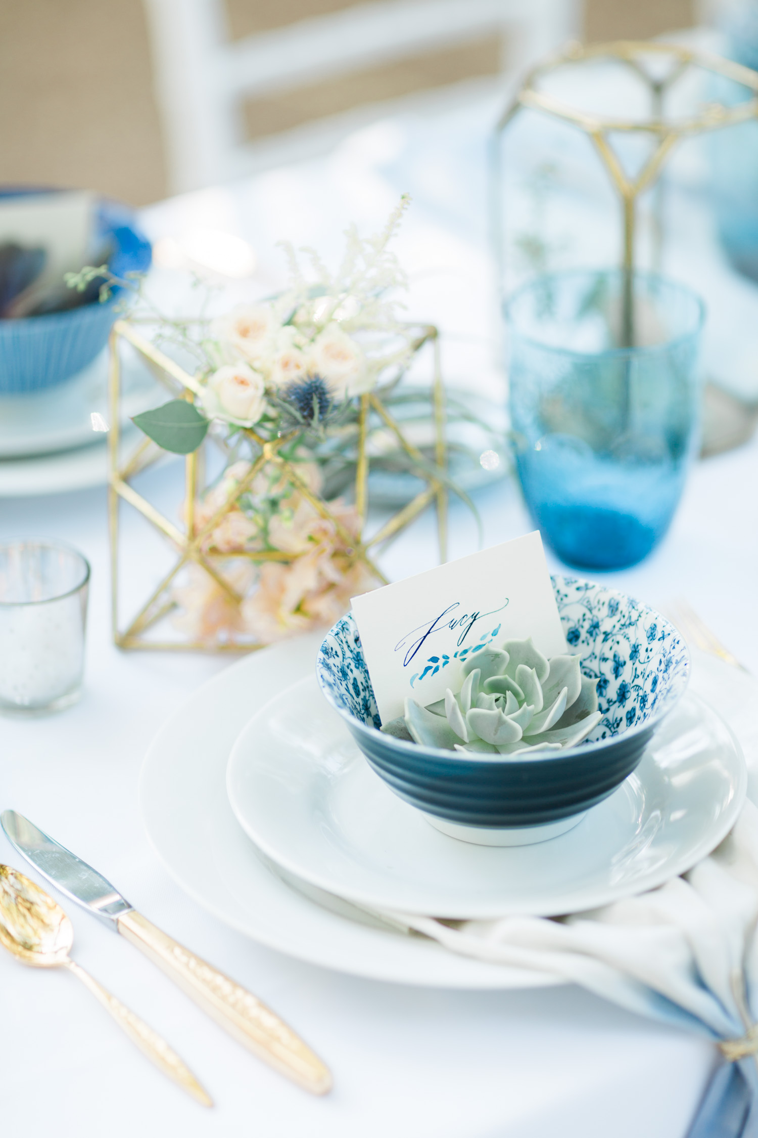 Indigo and gold place settings with stunning calligraphy by Betsy Dunlap