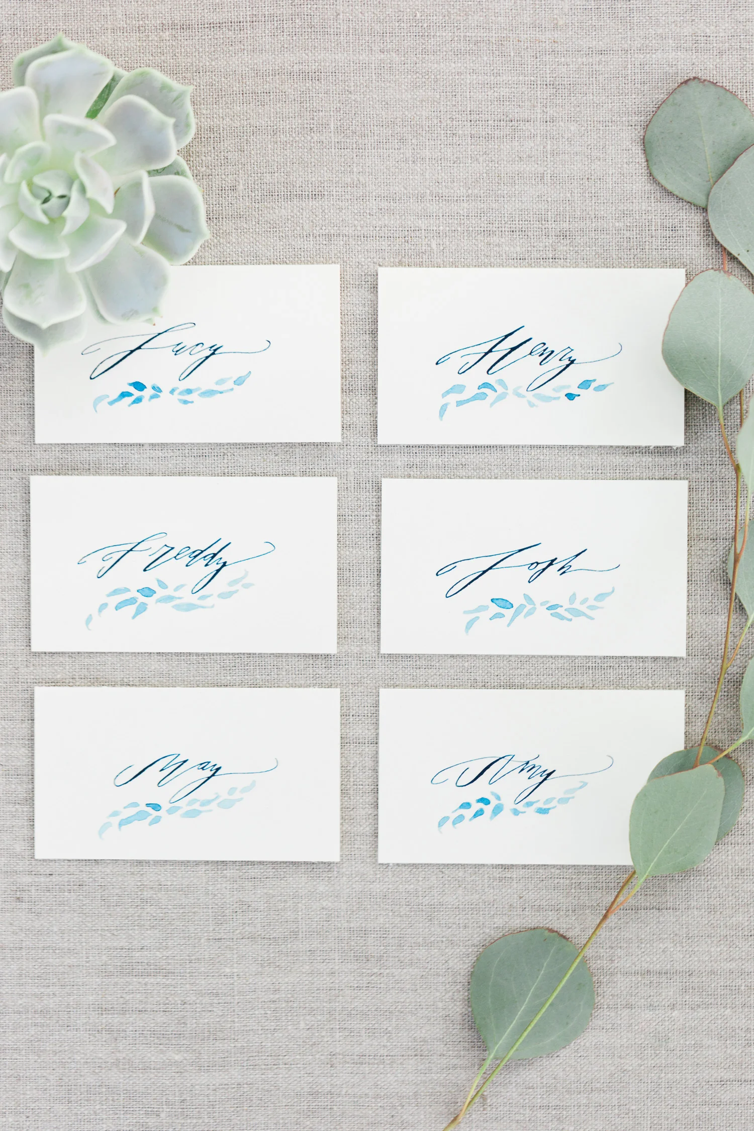 Beautiful place cards by Betsy Dunlap with indigo ink and leaf motifs