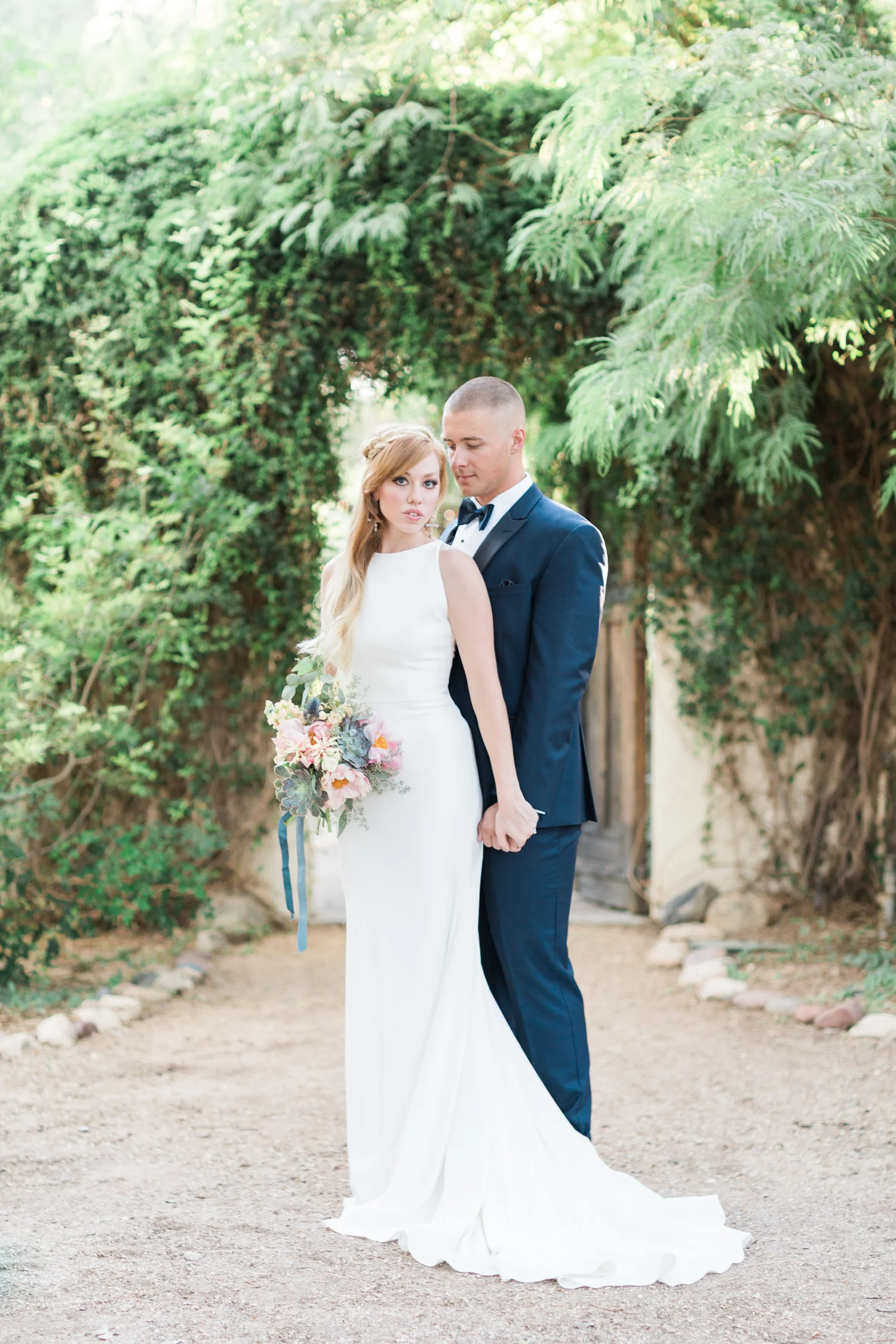 Bride and groom embracing at Tohono Chul Gardens