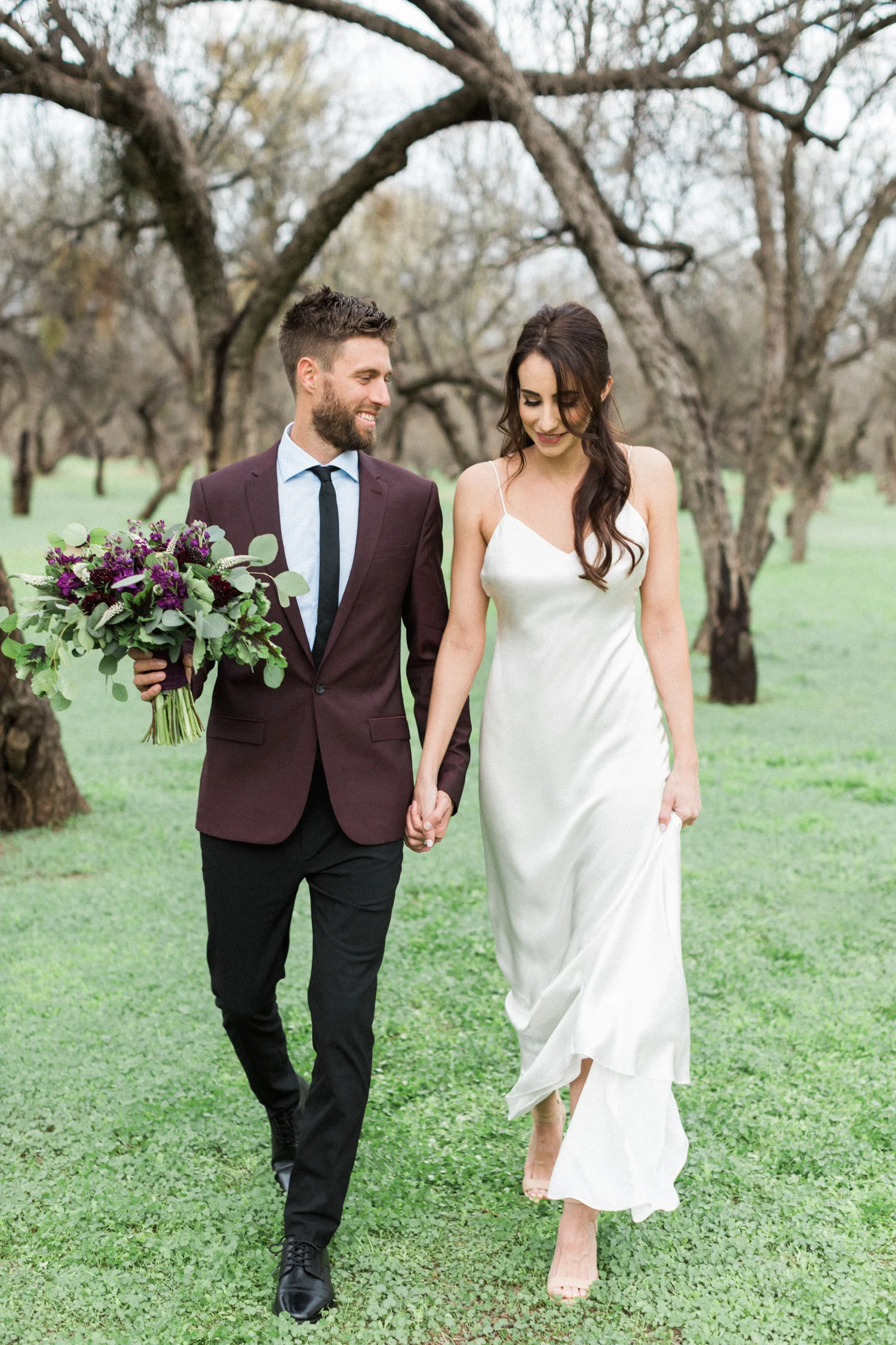 Bride and groom, walking through the mesquite trees along the Salt river in Phoenix after their elopement.