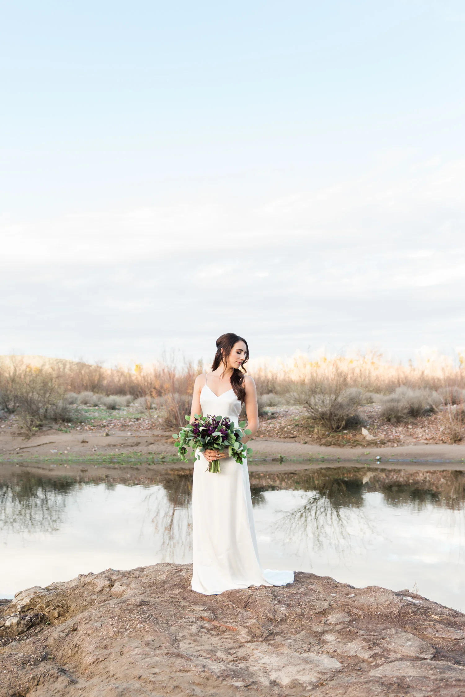 Bride holding her bouquet having a quiet moment on her wedding day.