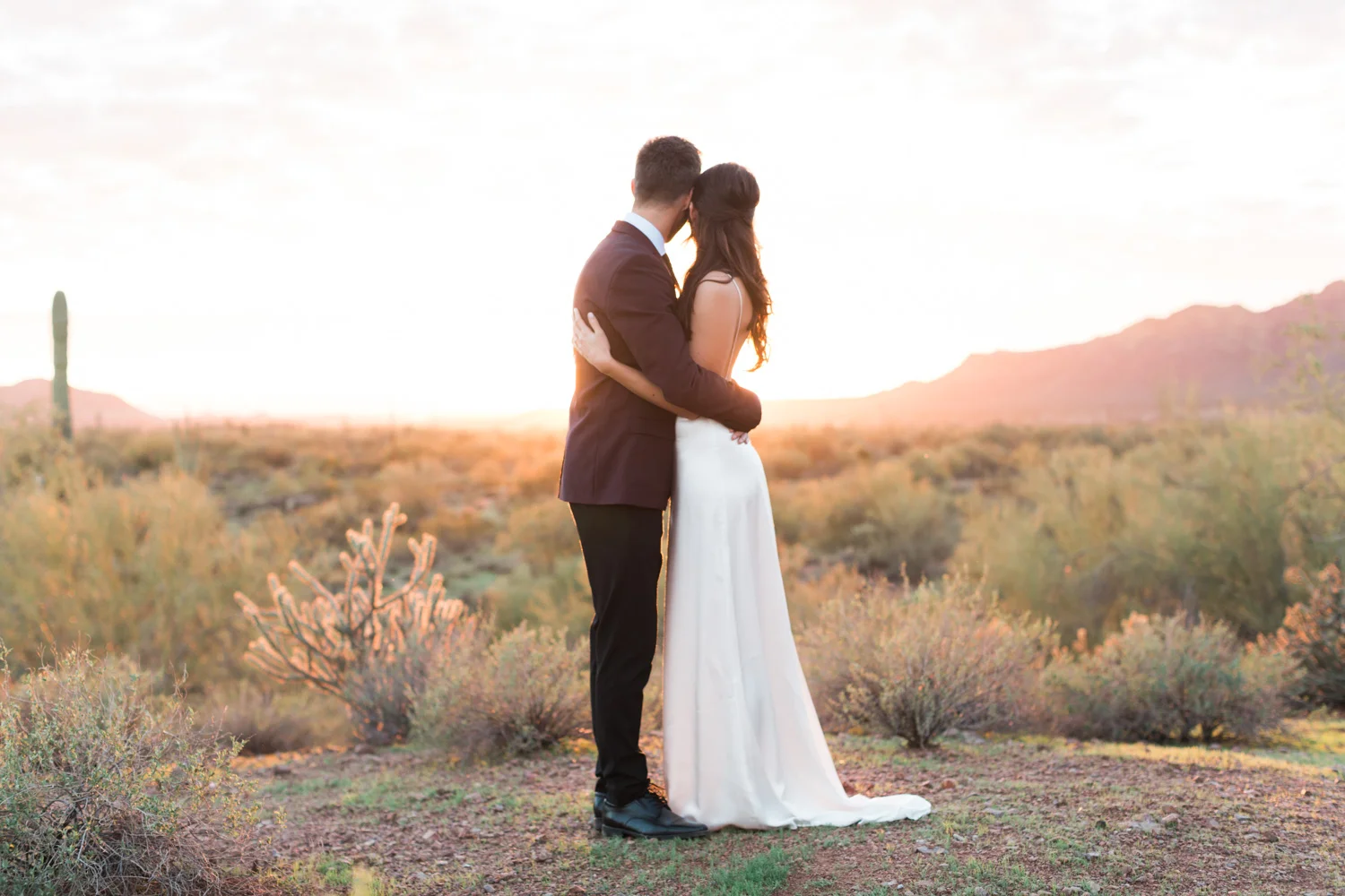 Peacefully looking our over the desert on their wedding day with a gorgeous Phoenix sunset in the background.