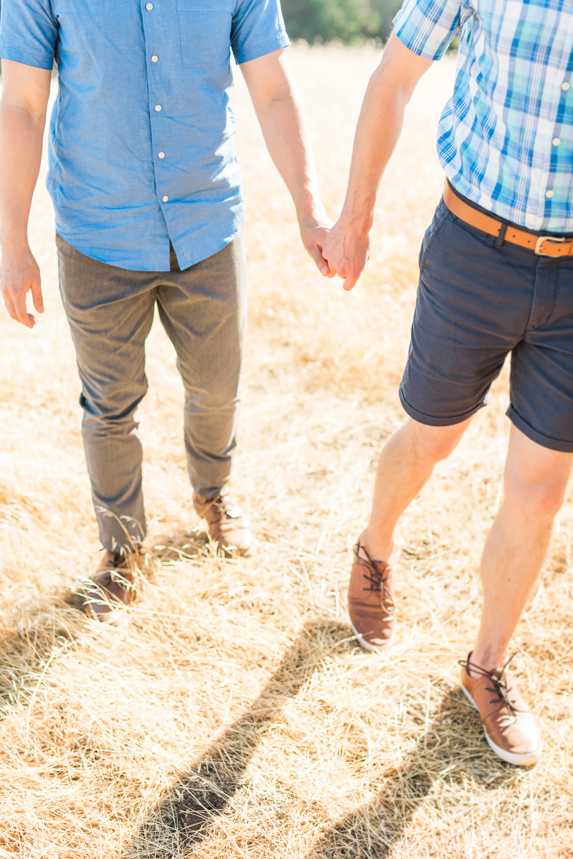 Grooms walking holding hands on their wedding day