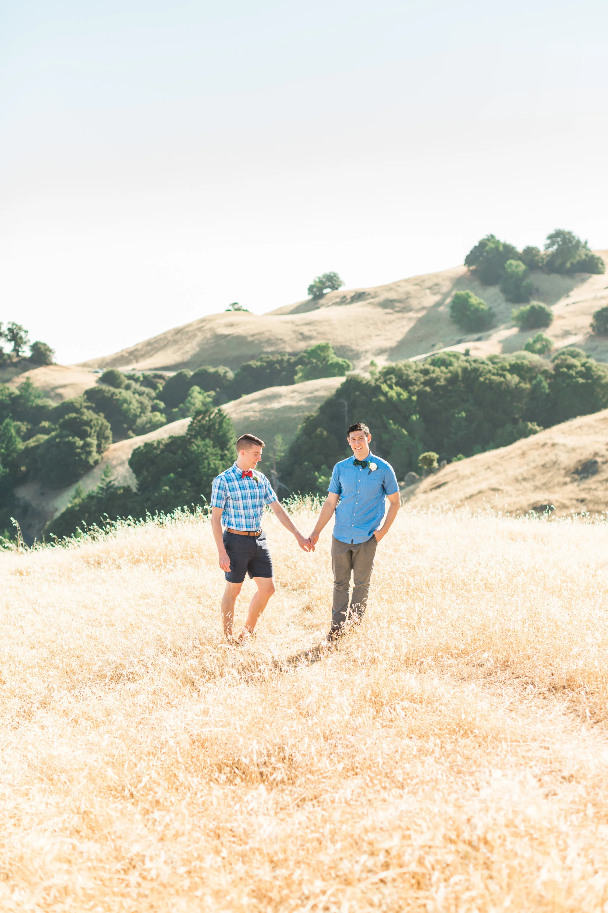 Two grooms in the rolling golden hills of Mount Tamalpais on their wedding day. Bay area wedding photographers Betsy & John