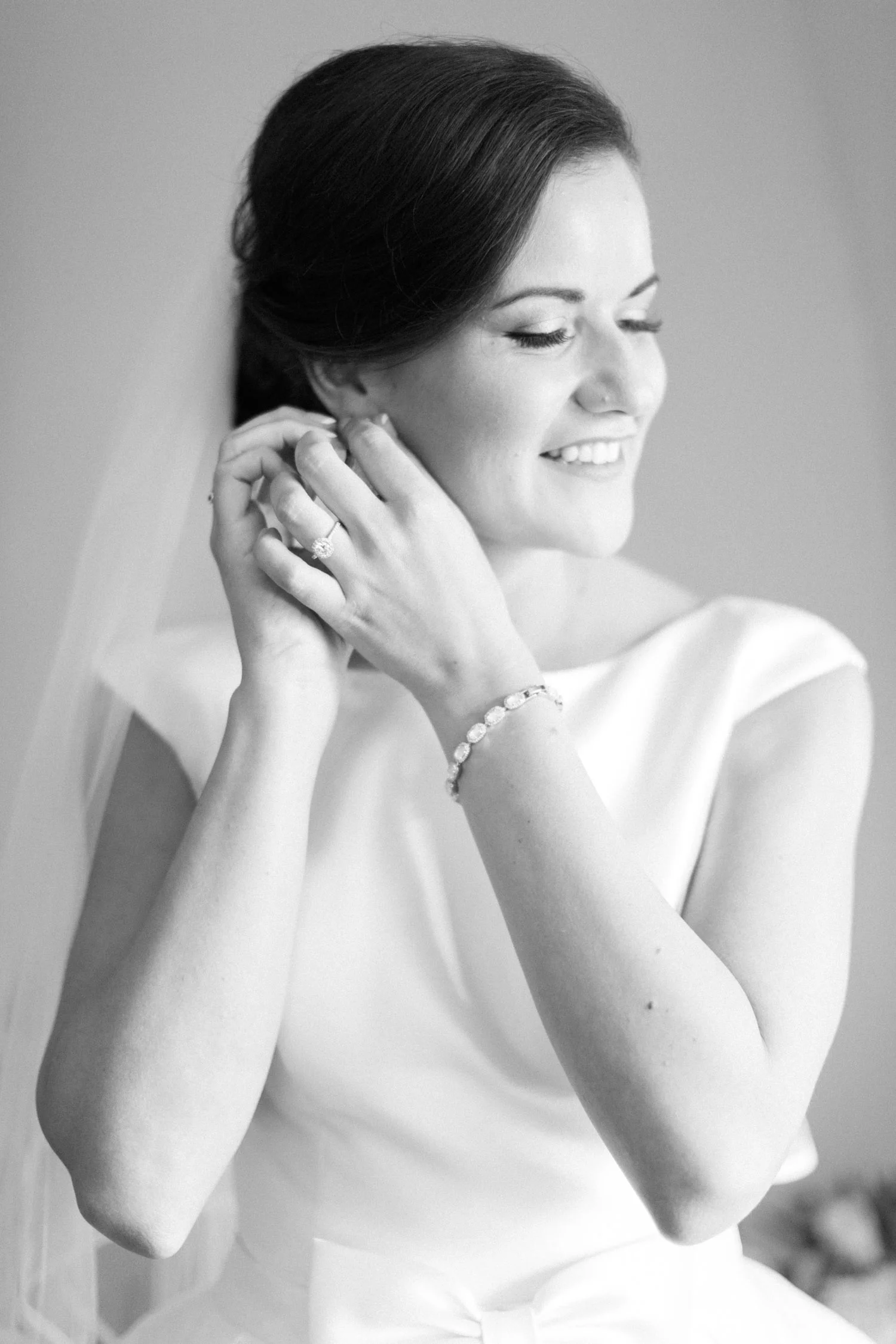 Bride putting on jewelry