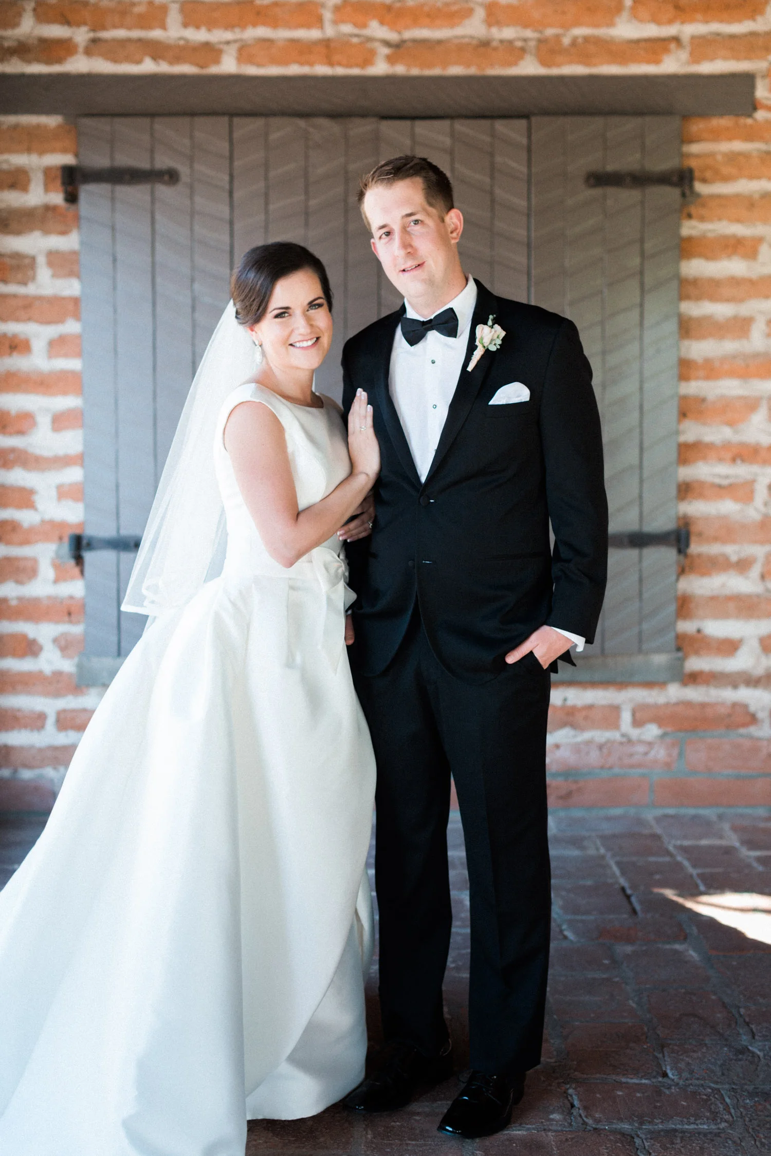 Bride and groom smiling at the camera 