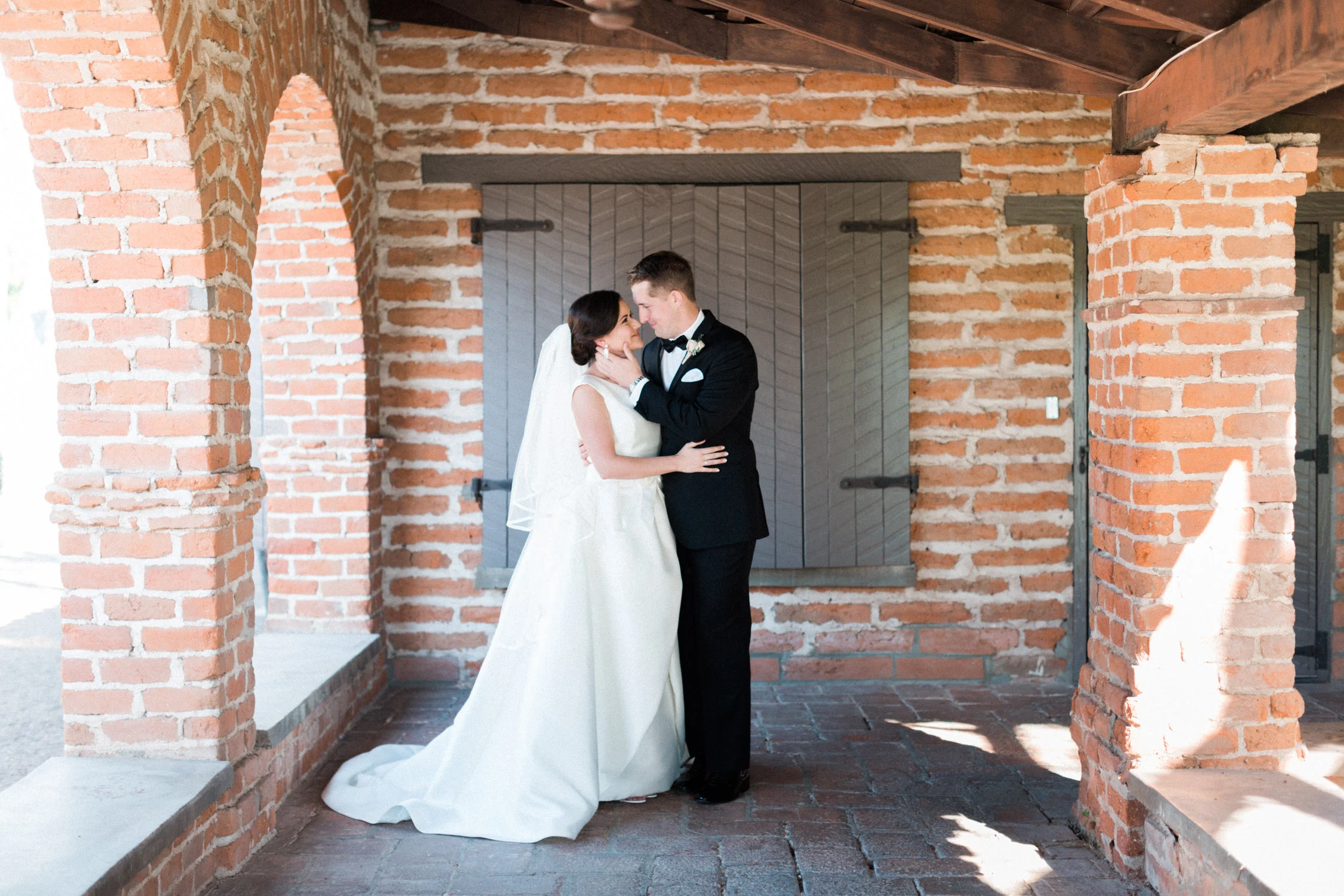 Bride and groom smiling at each other 