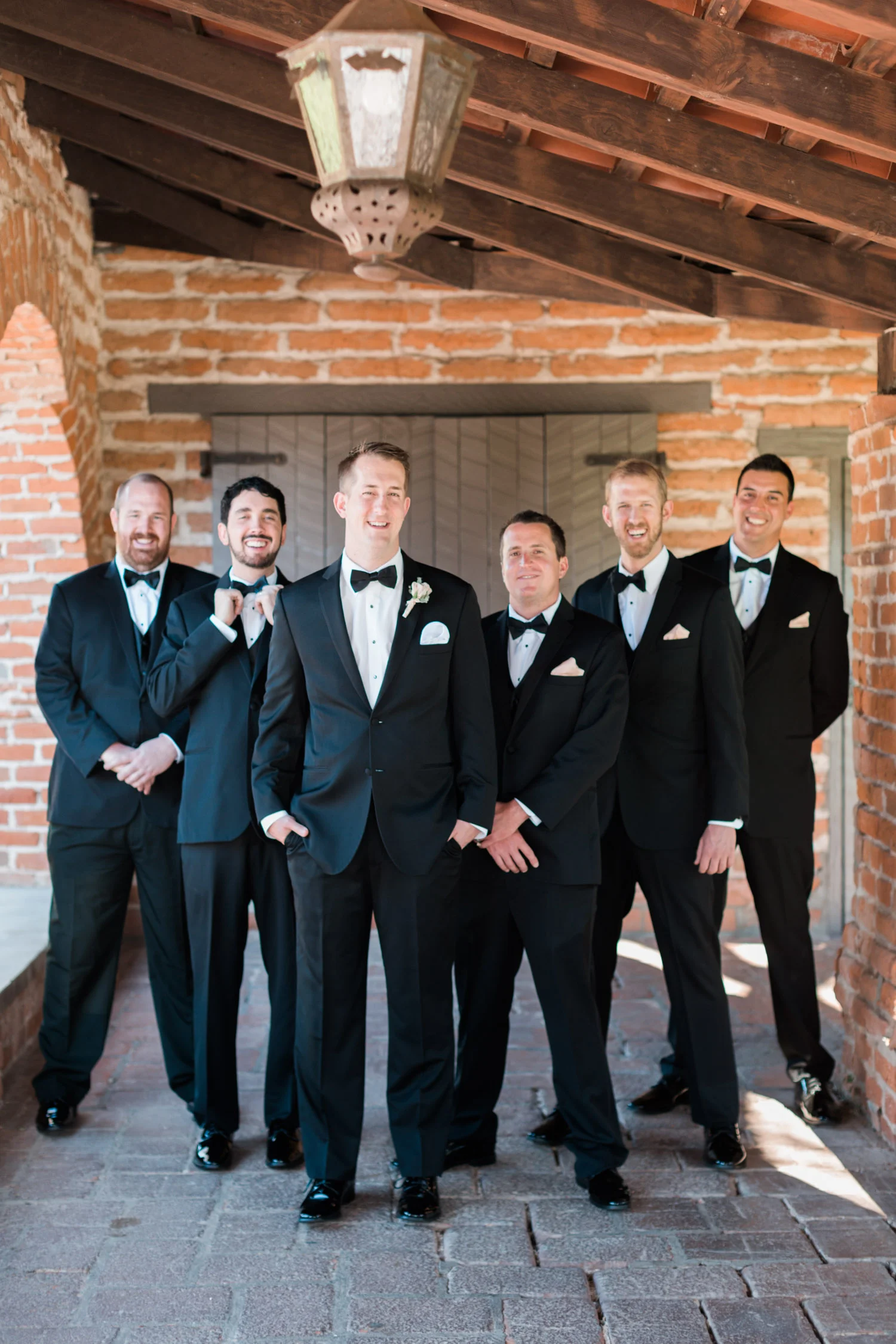 Groom with groomsmen in black tuxedos