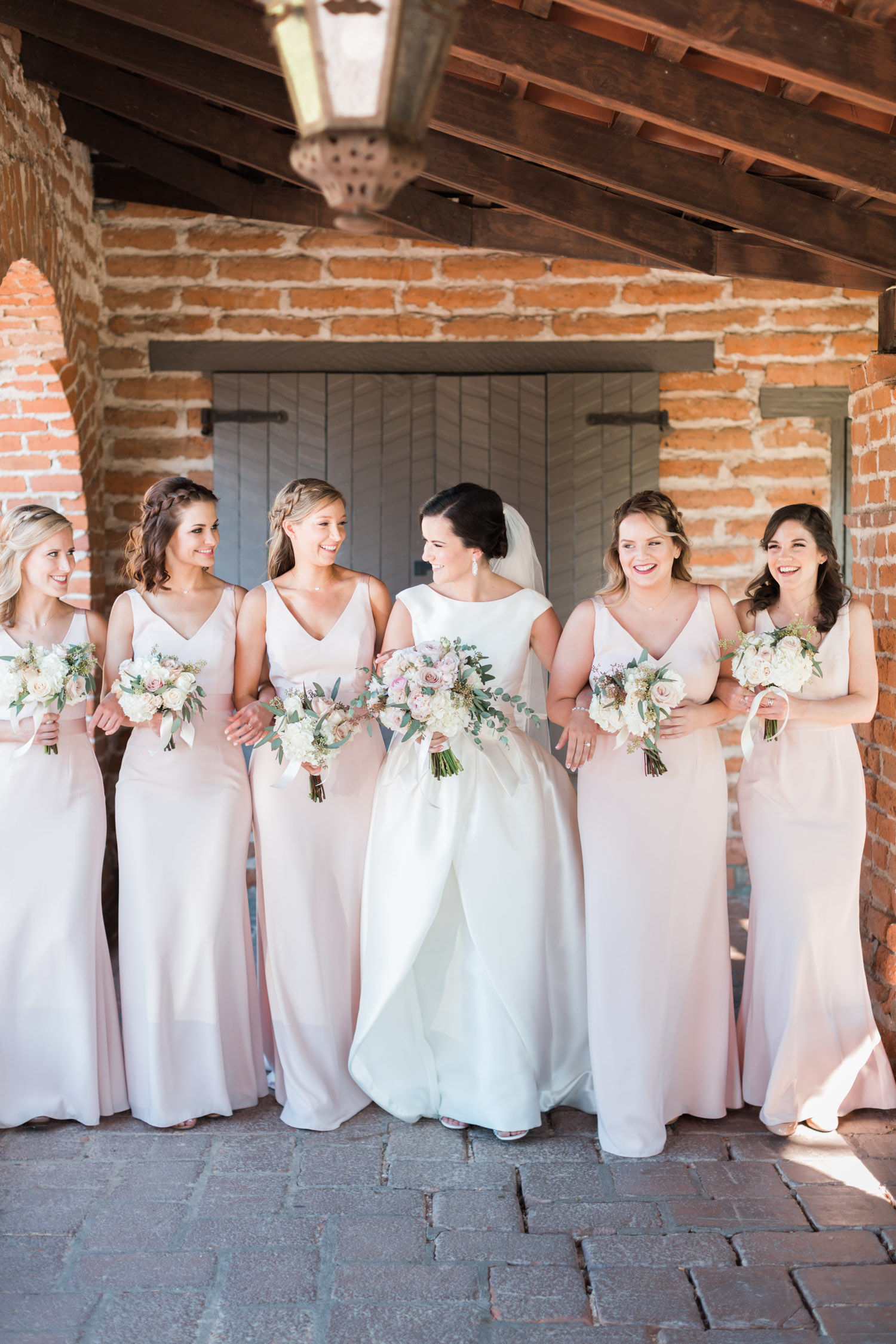 Bridesmaids walking with bride 