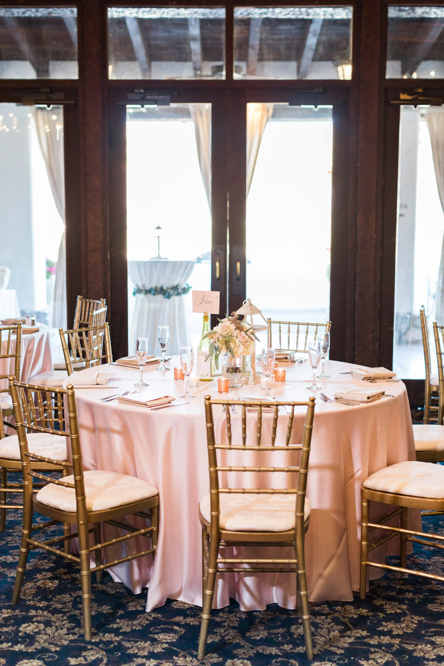 Ballroom set up with blush and gold chiavari chairs