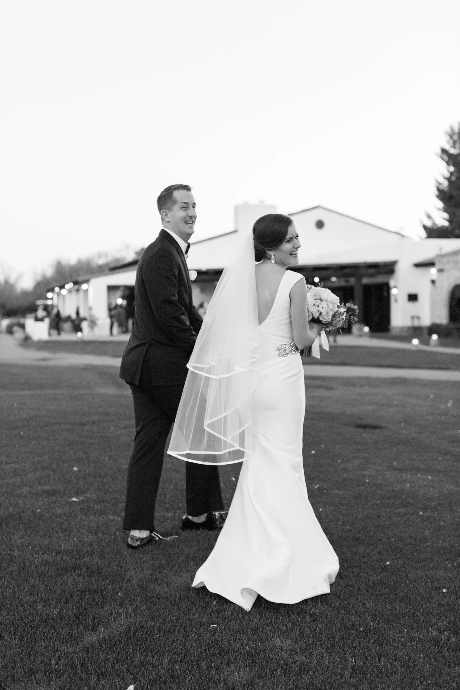 Couple laughing on their wedding day 