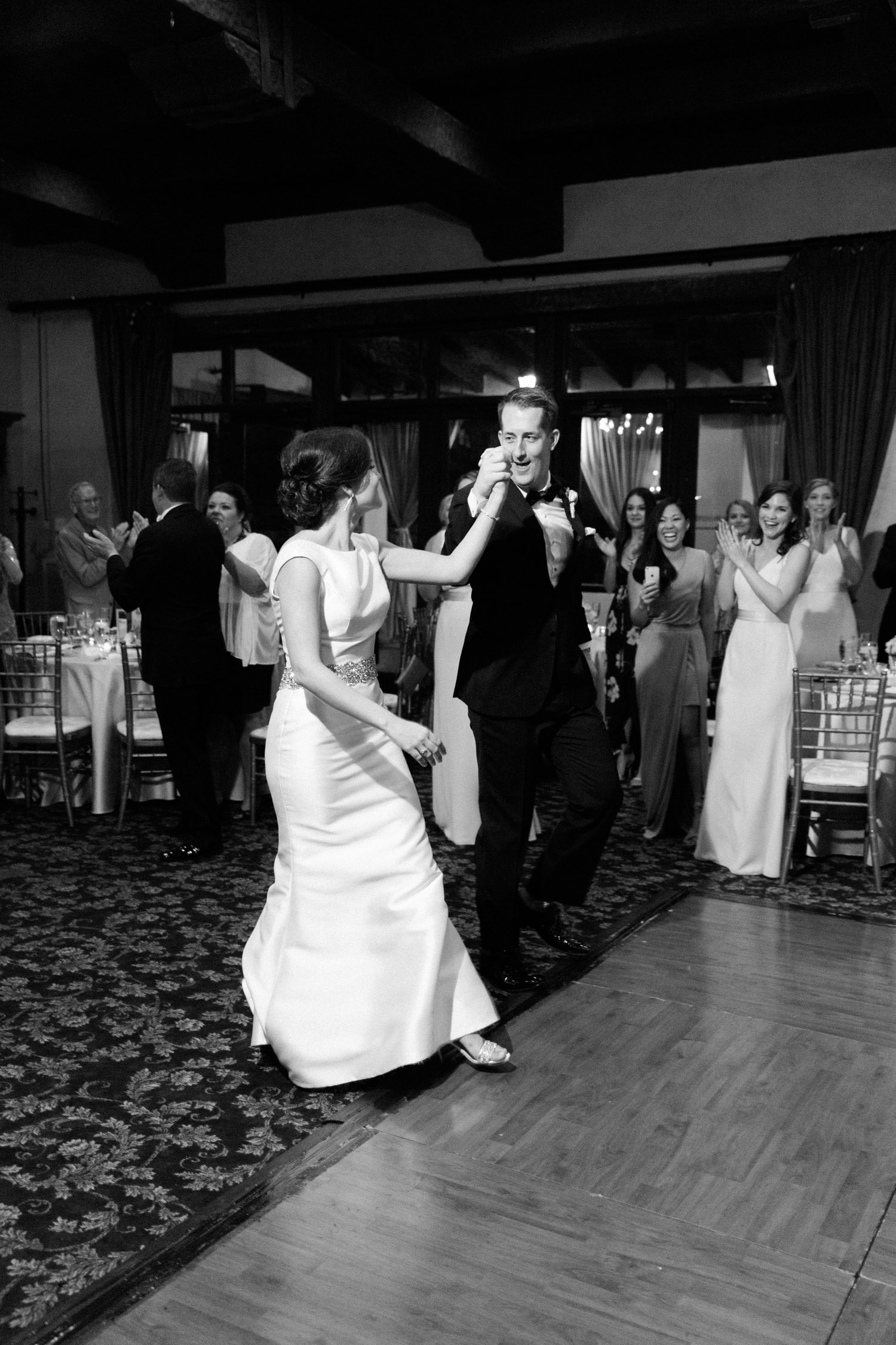 Bride and groom walking onto the dance floor for their first dance