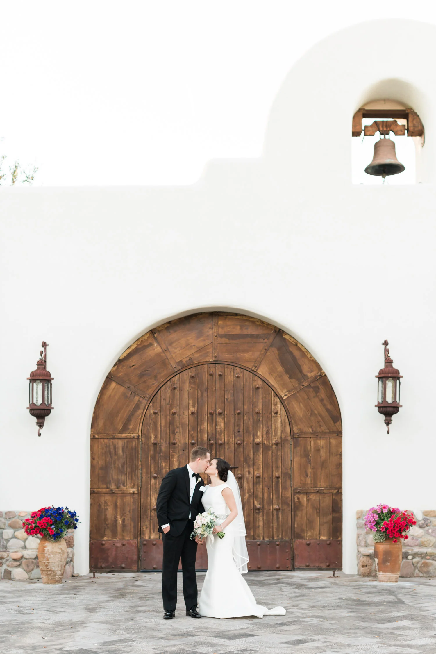 Bride & groom kissing in front of the chapel at Tubac Golf Resort 