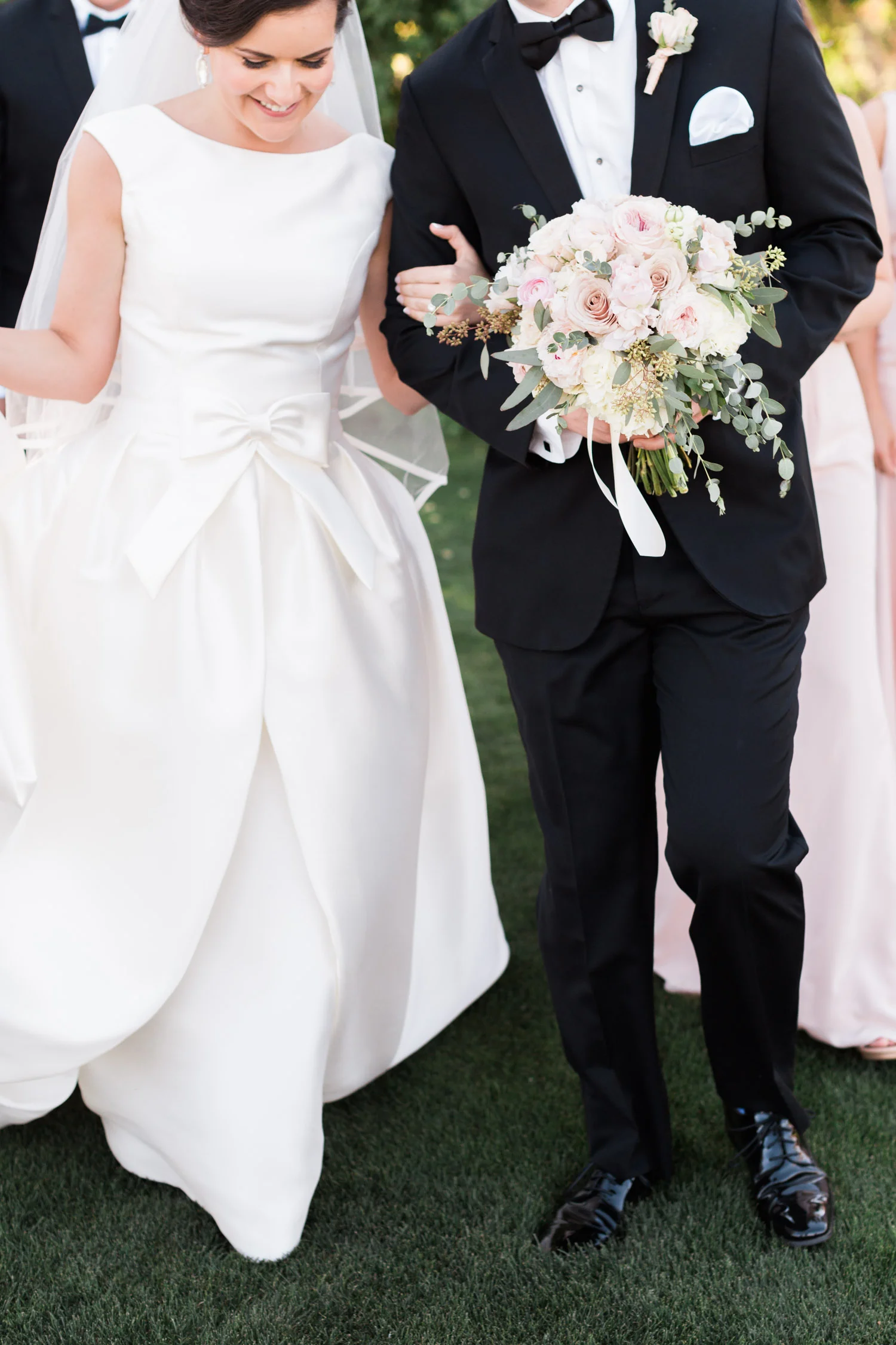 Smiling bride and groom with bridal party 