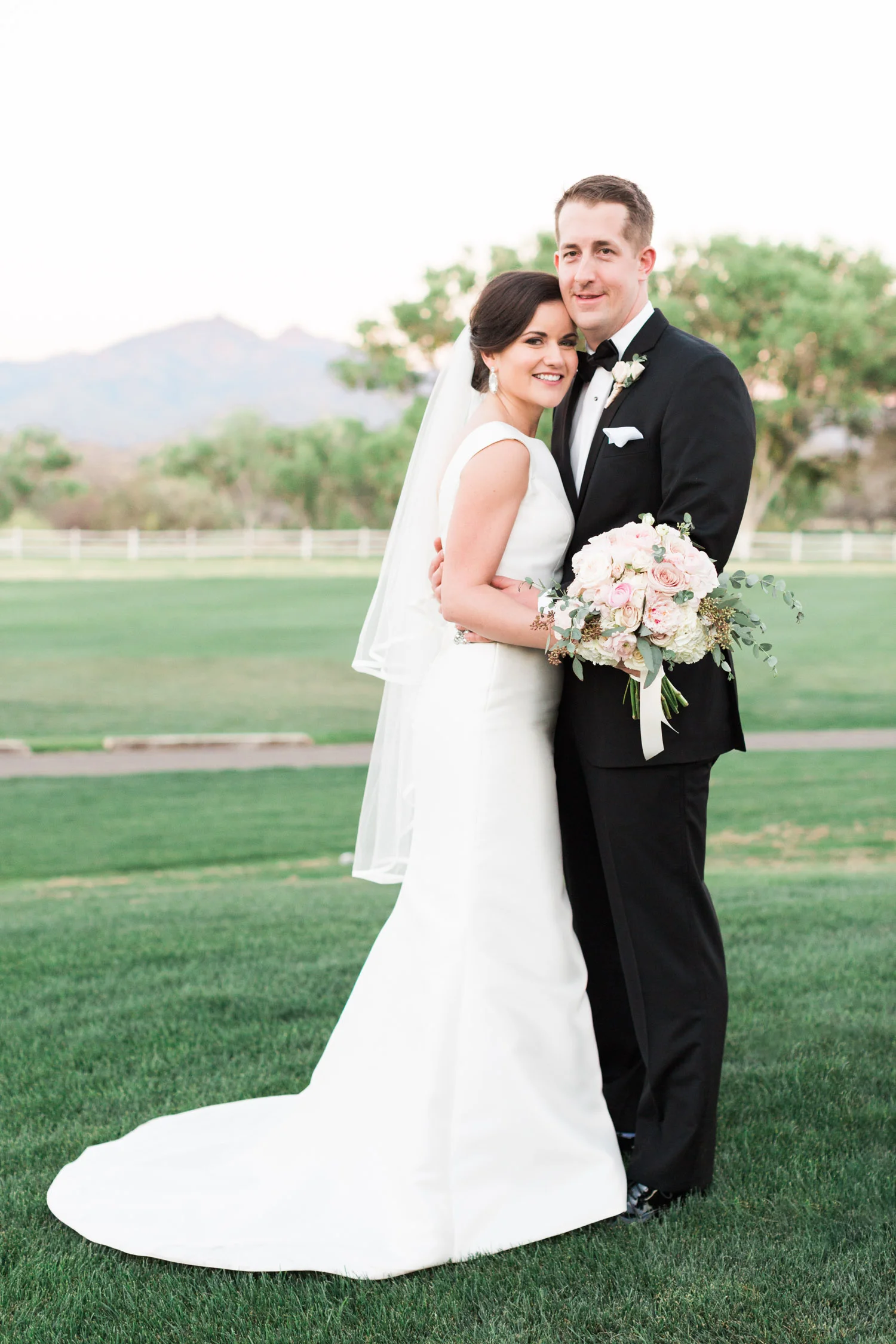 Couple smiling and hugging on their wedding day