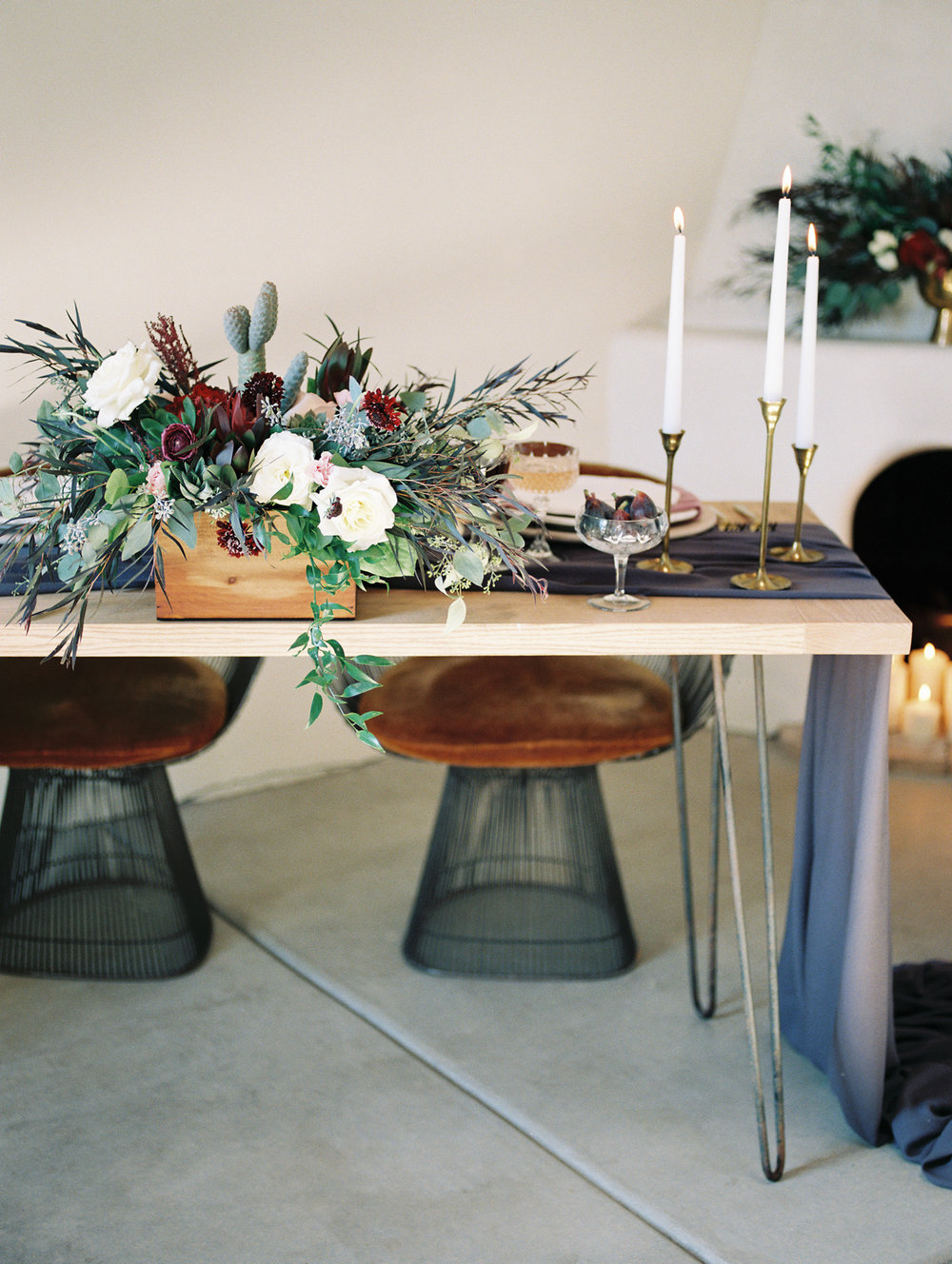  Hipster wedding reception set up with wild florals and tall candles in brass candlesticks 