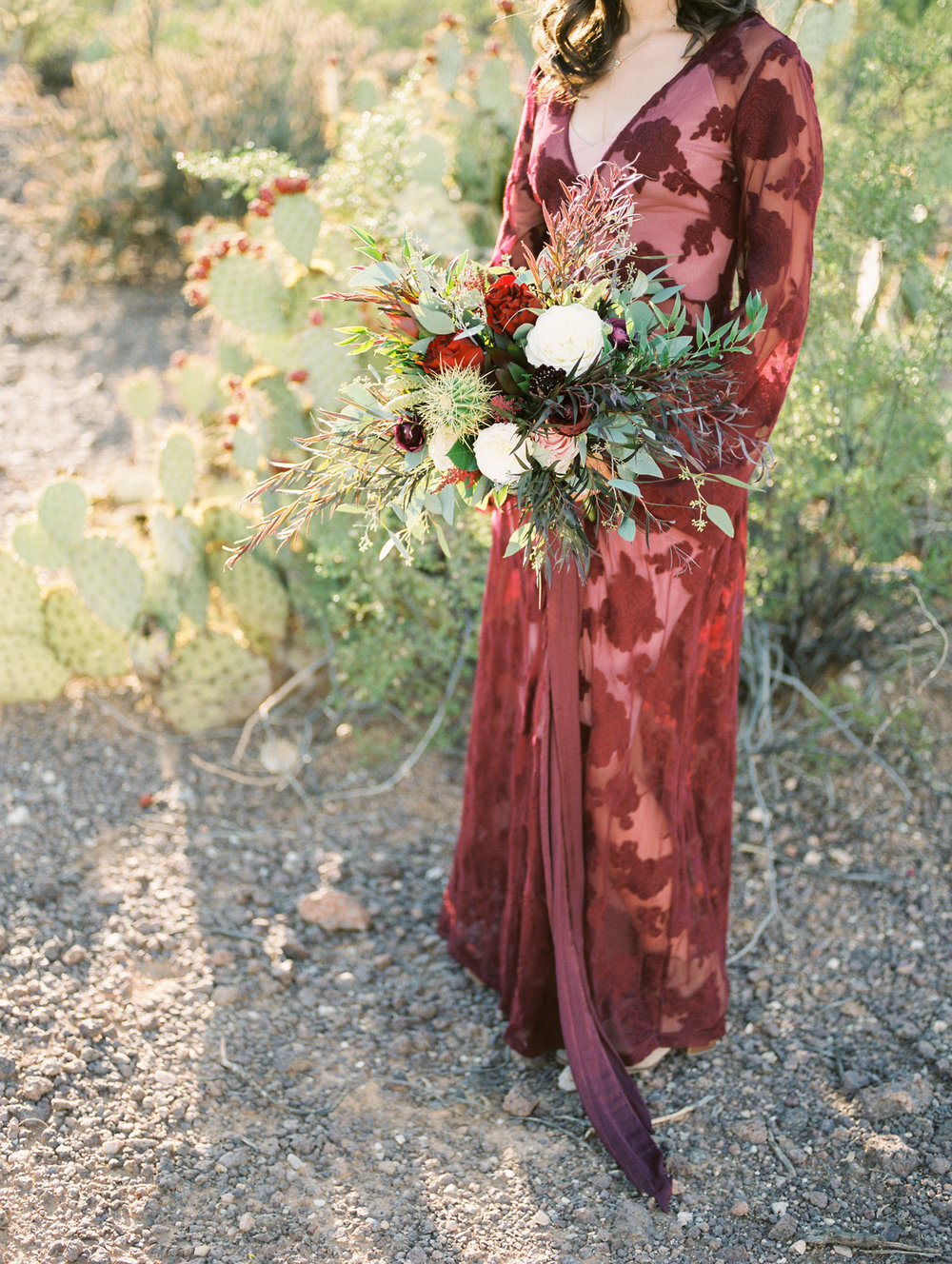  Stunning burgundy lace wedding dress paired with a fall desert bridal bouquet with cactus&nbsp; 