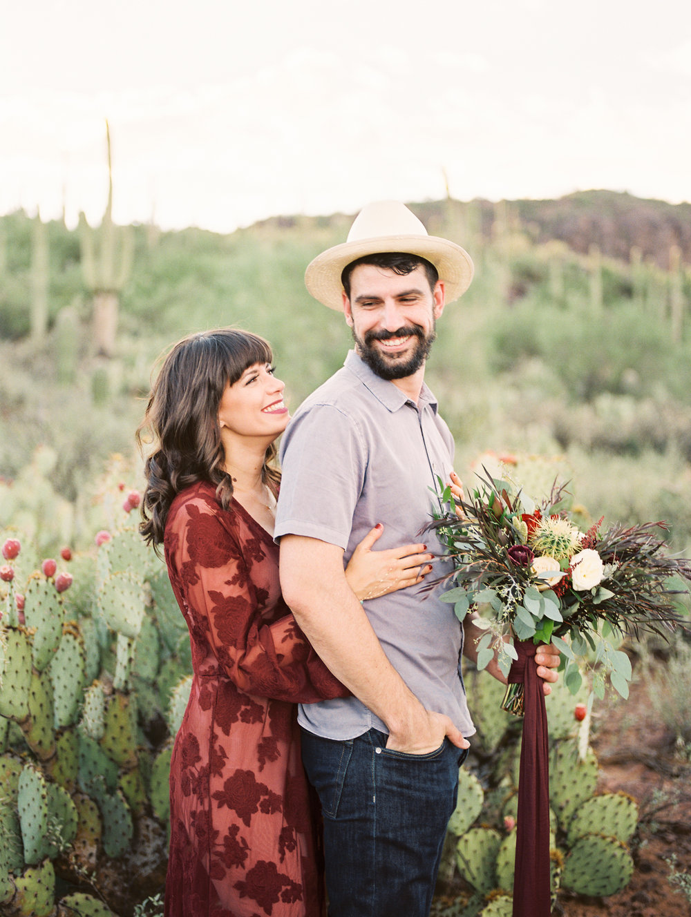  Couple smiling at each other with cactus in the background. Tucson wedding&nbsp; 