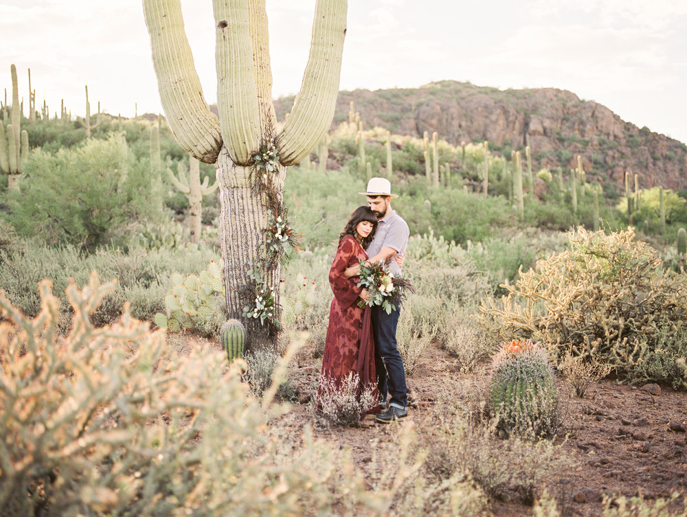  Couple in the Tucson desert with tons of saguaros in the background&nbsp; 