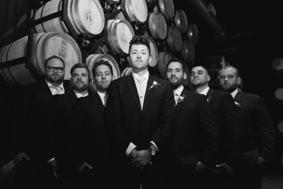 Groomsmen in barrel room at Temecula winery, Wiens Family Cellars 