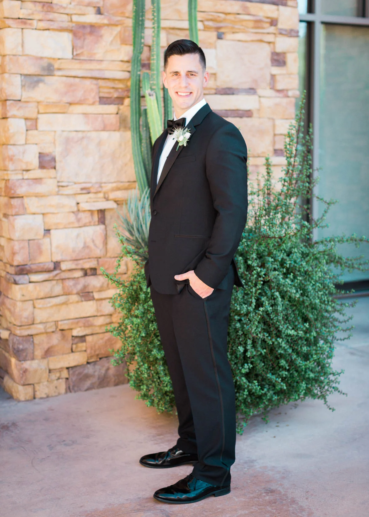 Handsome groom in black tuxedo captured by Tucson Wedding Photographers Betsy & John 