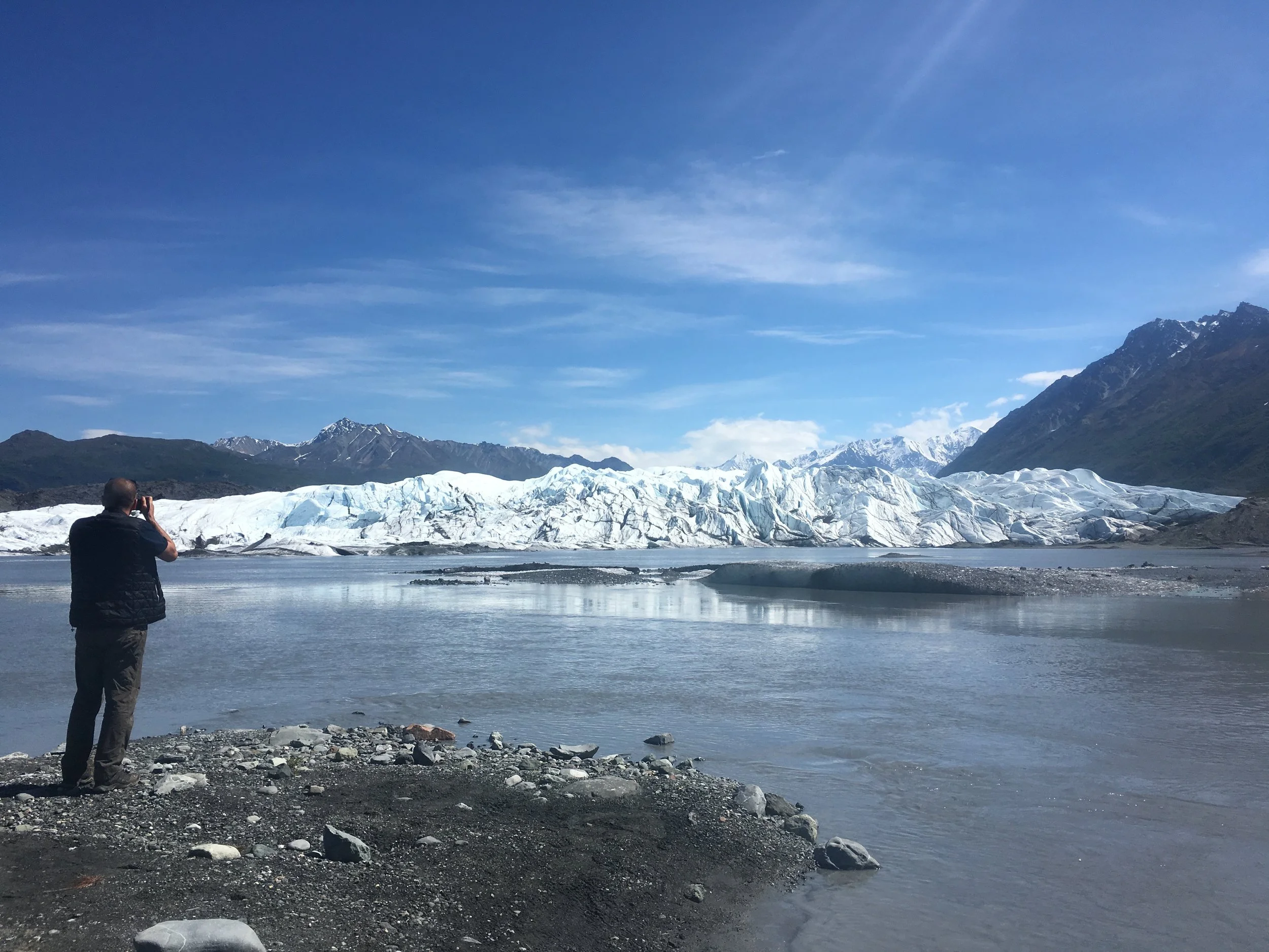 Benji taking photos of the edge of Matanuska glacier from across the water, near the parking area.