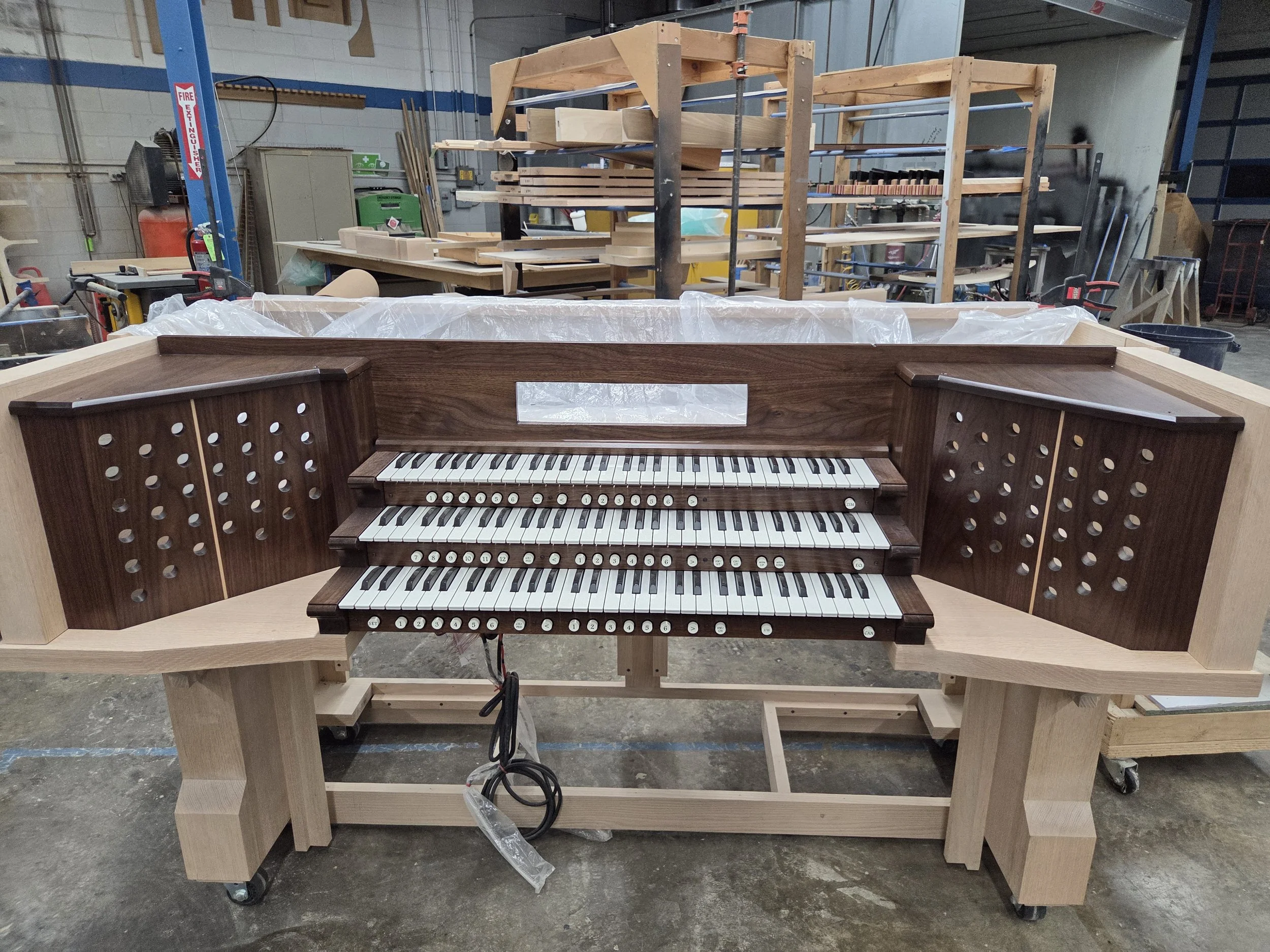 Finished walnut console interior with keyboards and pistons 