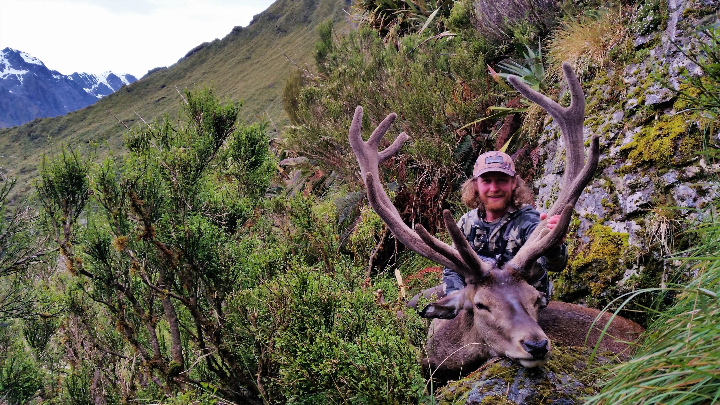 The author with a mature stag showing solid timber, length and tines. The pedicles appear low and more toward the side of the head. Note the left antler lacks length in the bez and the rear royal, possibly from an injury.