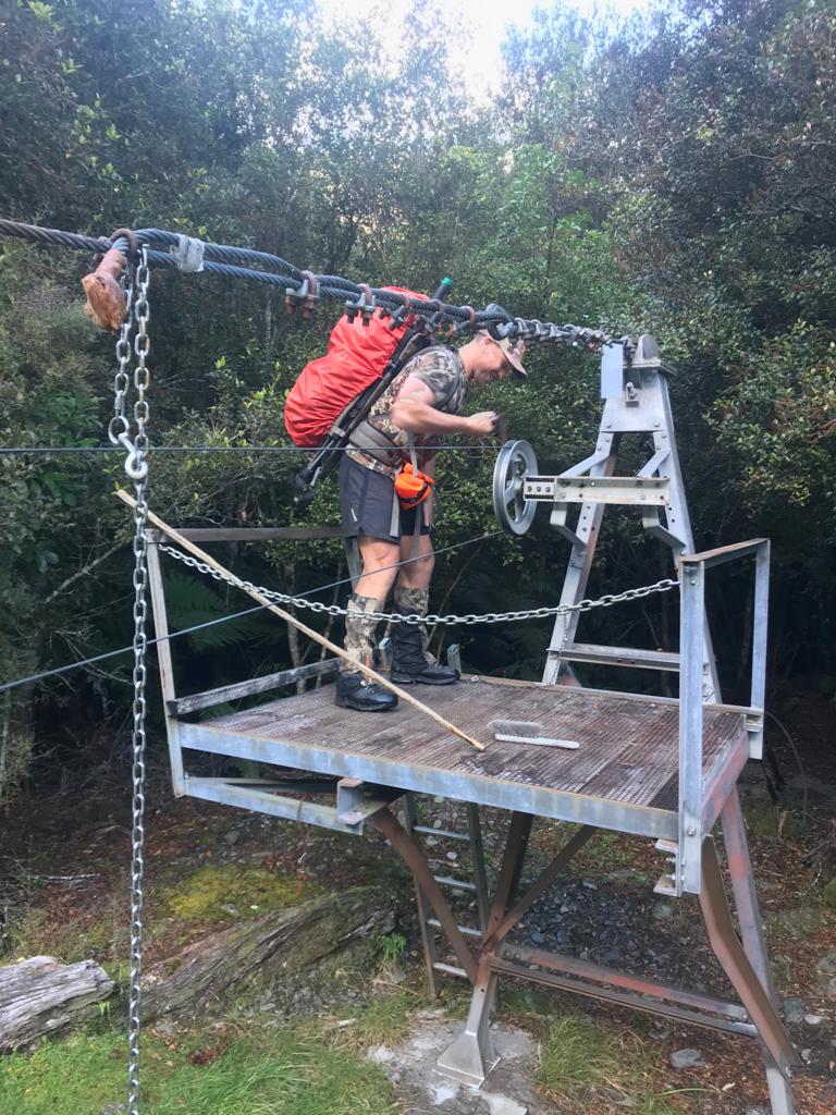 Winding in the carriage on the cable-way across the Hokitika River.
