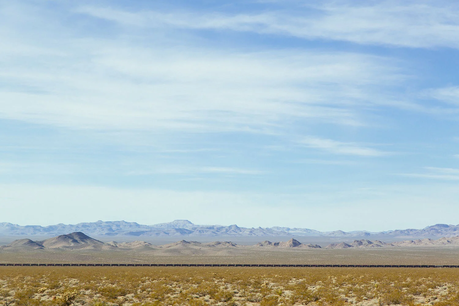 freight trains in the arizona desert photo by ryan kuratomi