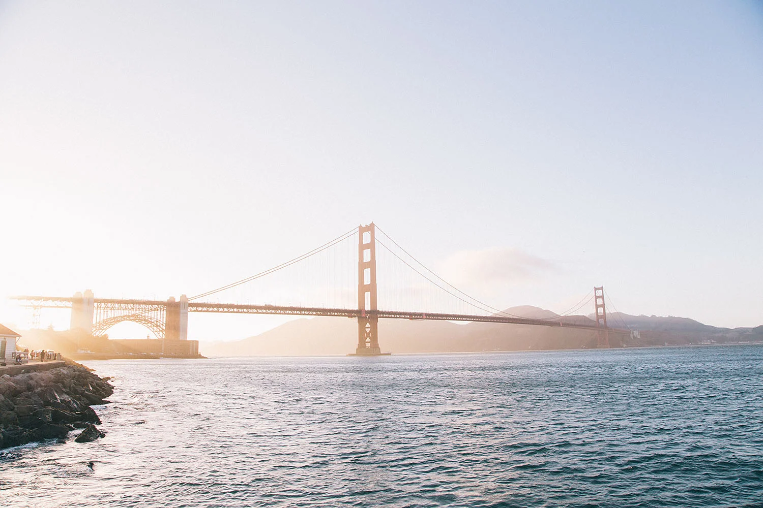 the golden gate bridge at golden hour photo by ryan kuratomi