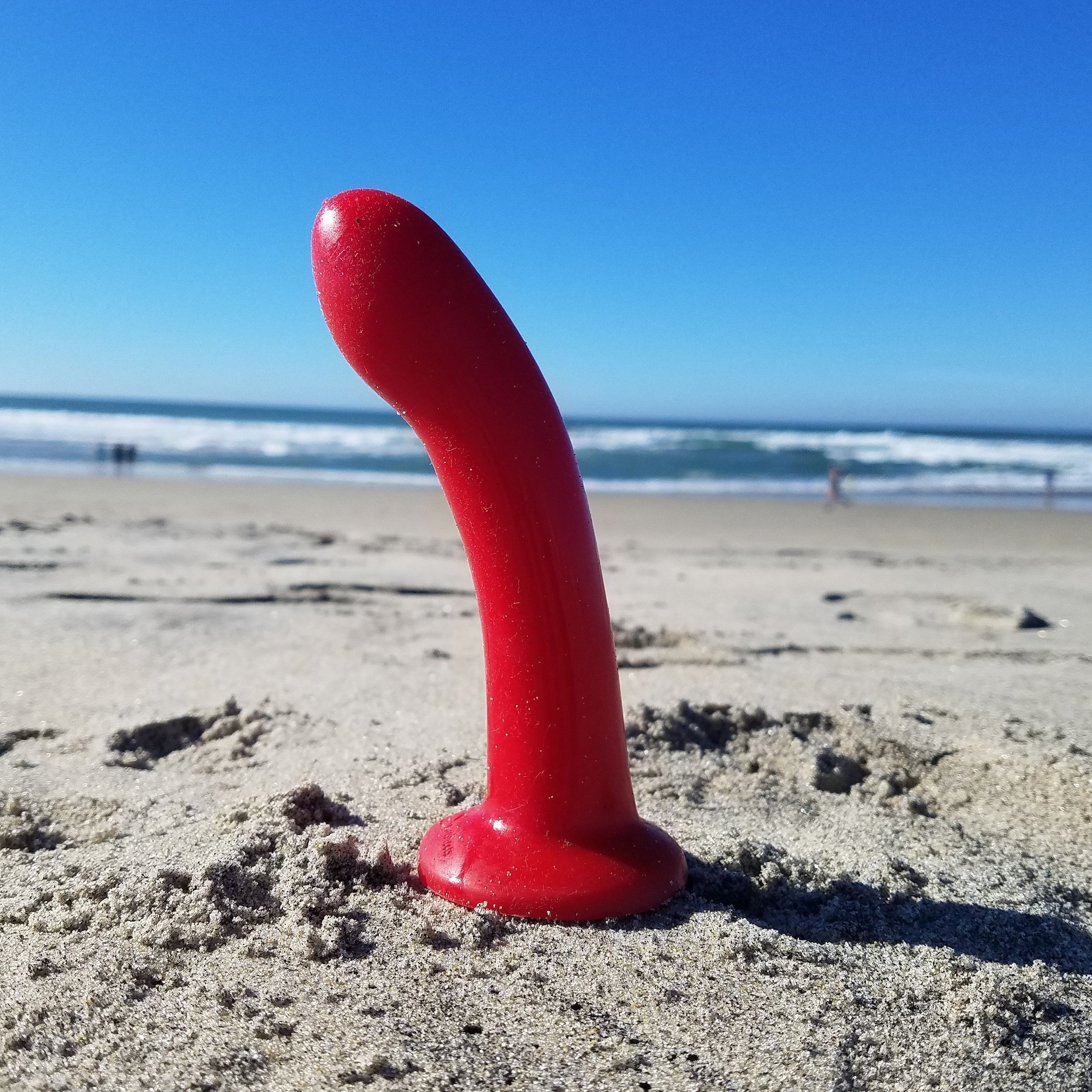Red dildo on beach Sex Toys.jpg