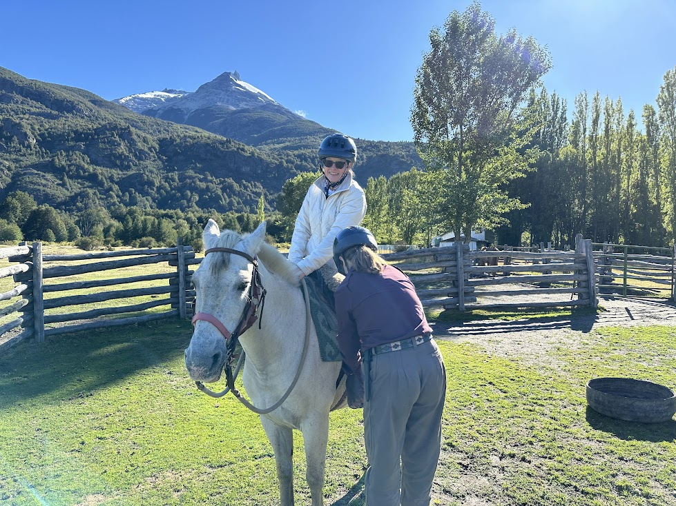 Ceniza getting mounted at ranch for a horse riding trip