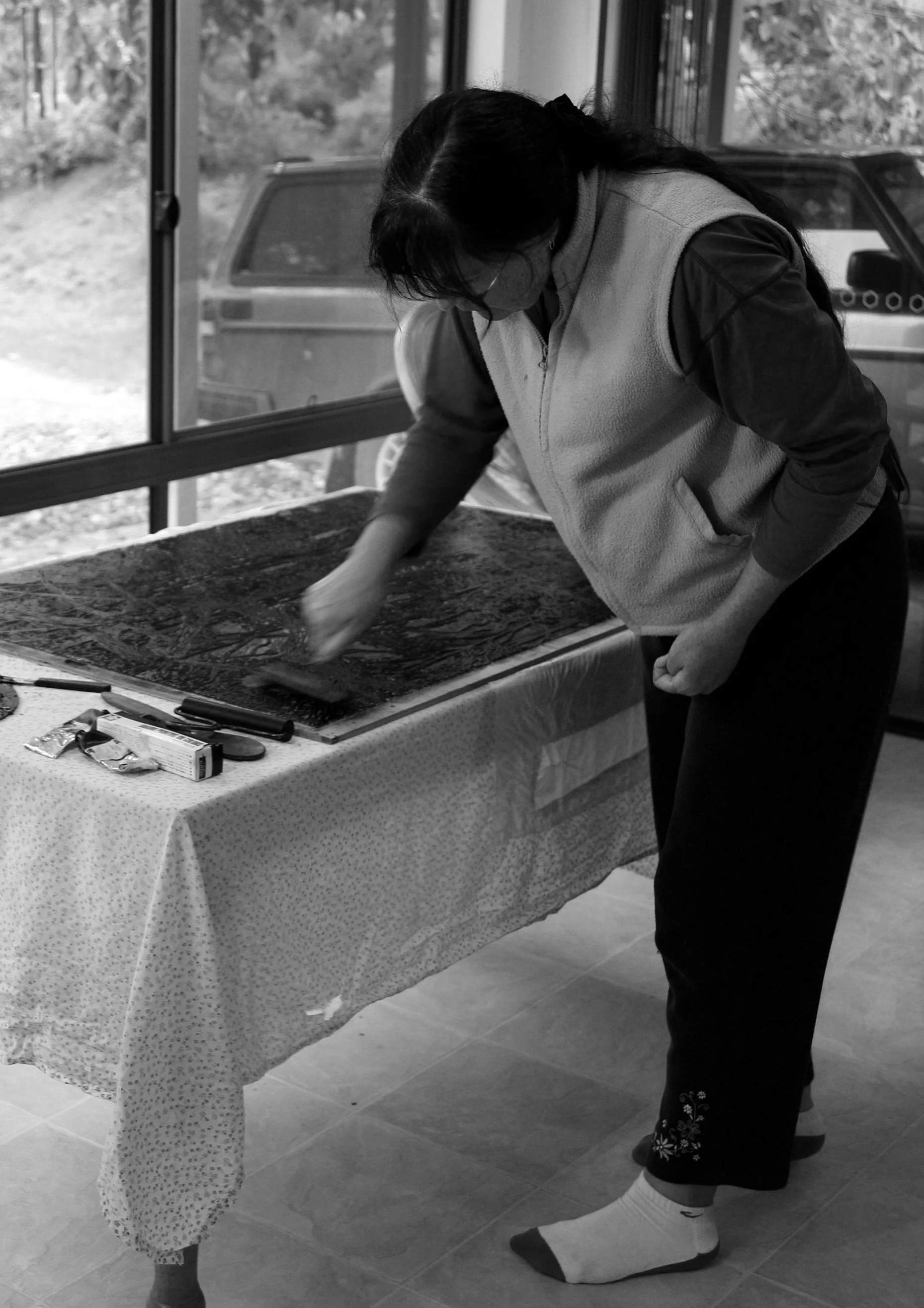  After cutting, it is ready to print. Black ink is rolled over the surface of the lino, paper is placed over the ink and the whole thing is either rolled in a press, or I rub the back of the paper firmly with a wooden spoon. 